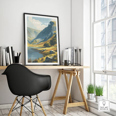 Framed Cadair Idris travel poster with mountain landscape on modern office desk