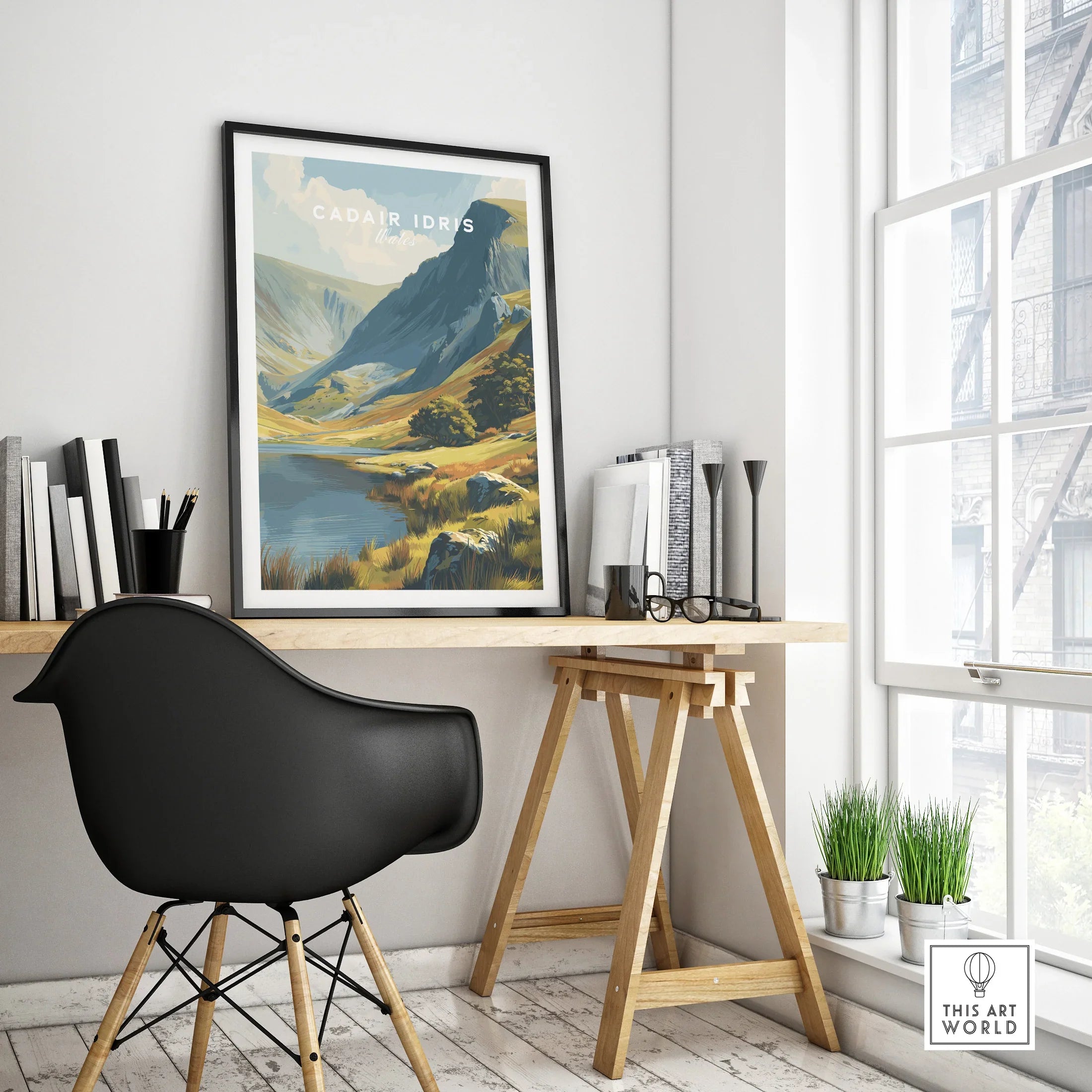 Framed Cadair Idris travel poster with mountain landscape on modern office desk