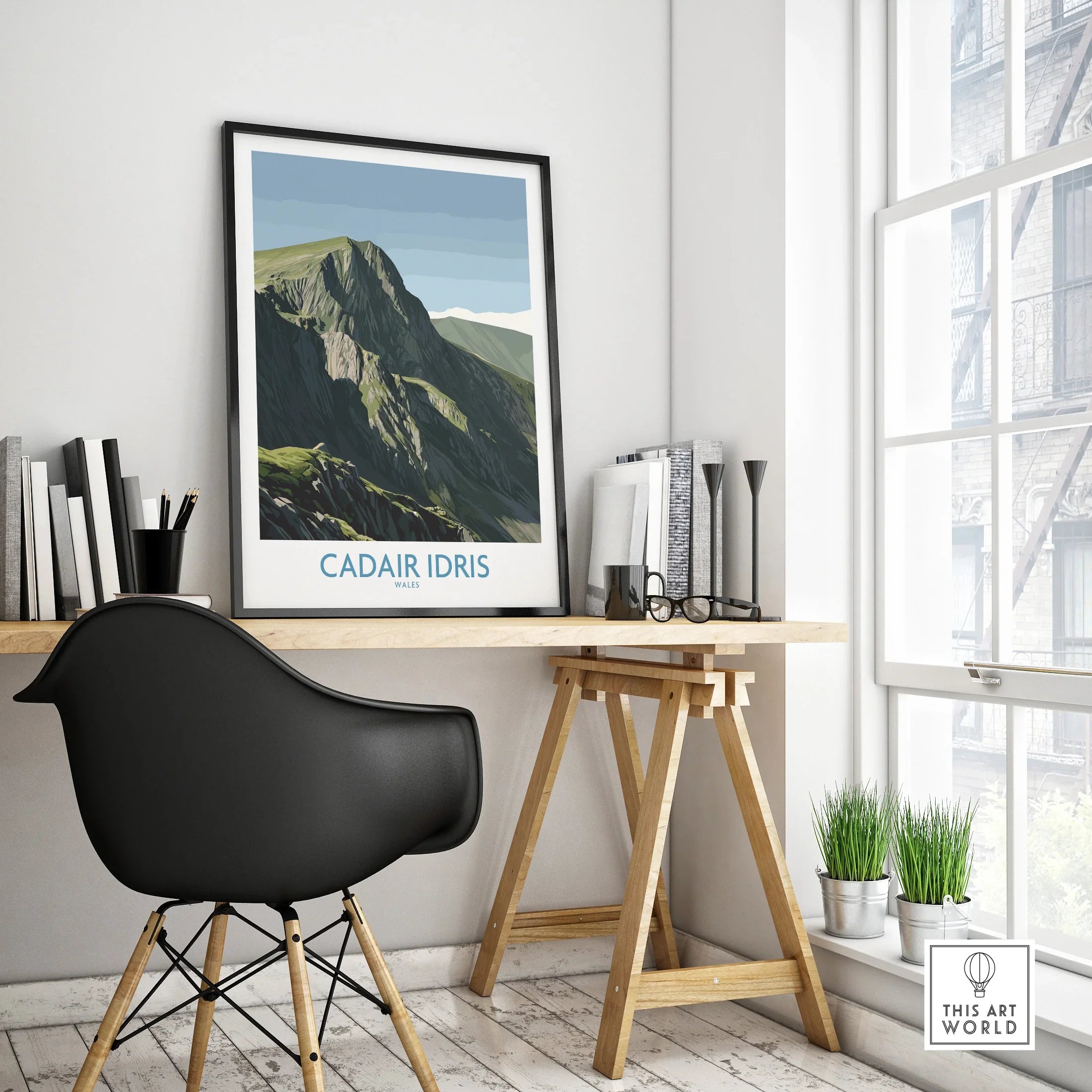 Framed Cadair Idris Wales travel poster on modern office desk by window