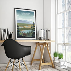 Framed Cairngorms National Park travel poster on modern office desk with black chair