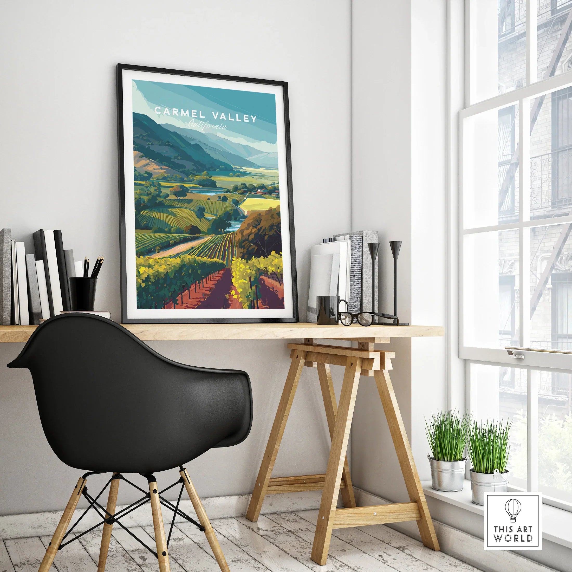 Framed Carmel Valley travel poster on modern office desk with black chair and decor