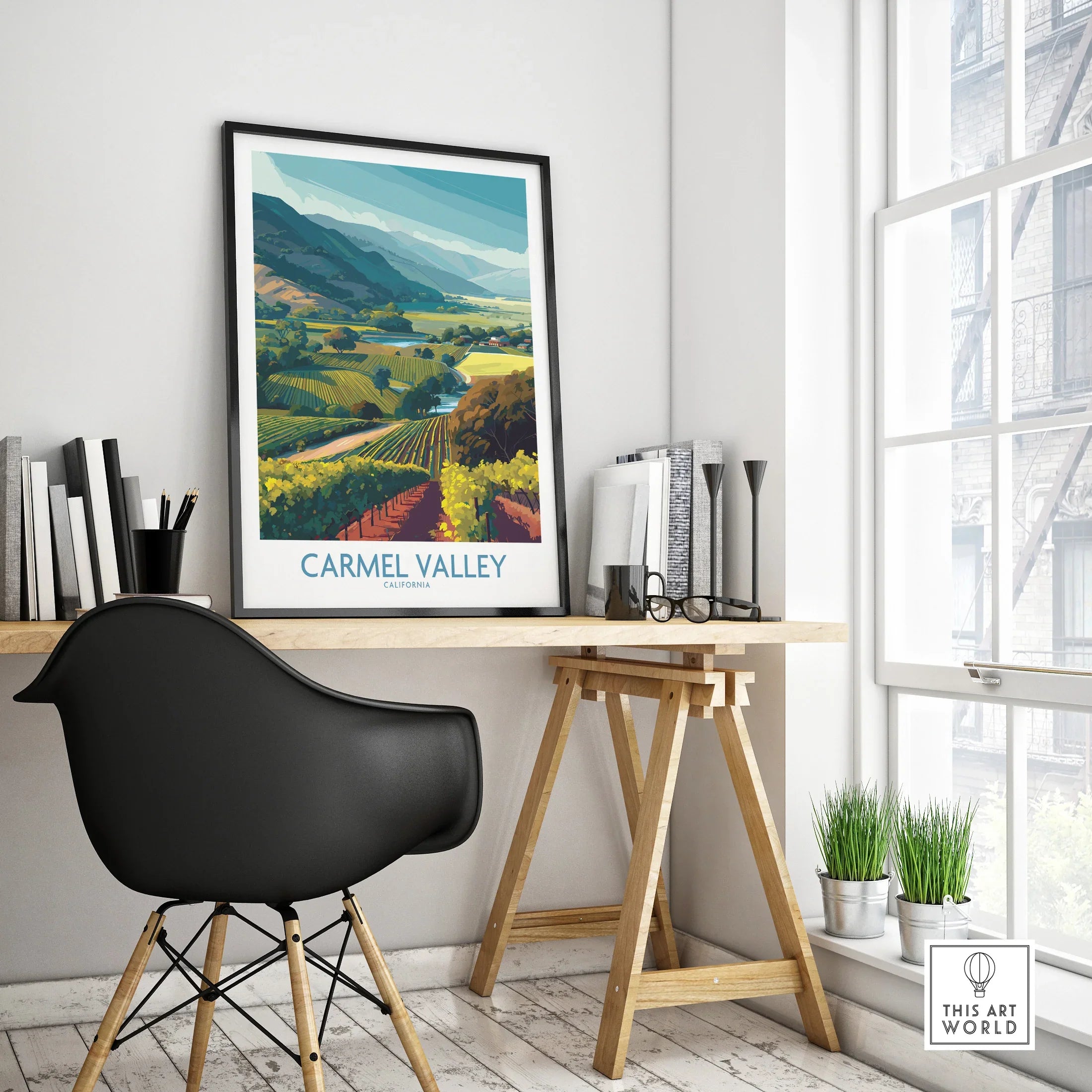 Framed Carmel Valley travel poster on modern office desk with black chair and decor
