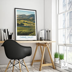 Carmel Valley travel poster in black frame on modern office desk, natural light, stylish decor