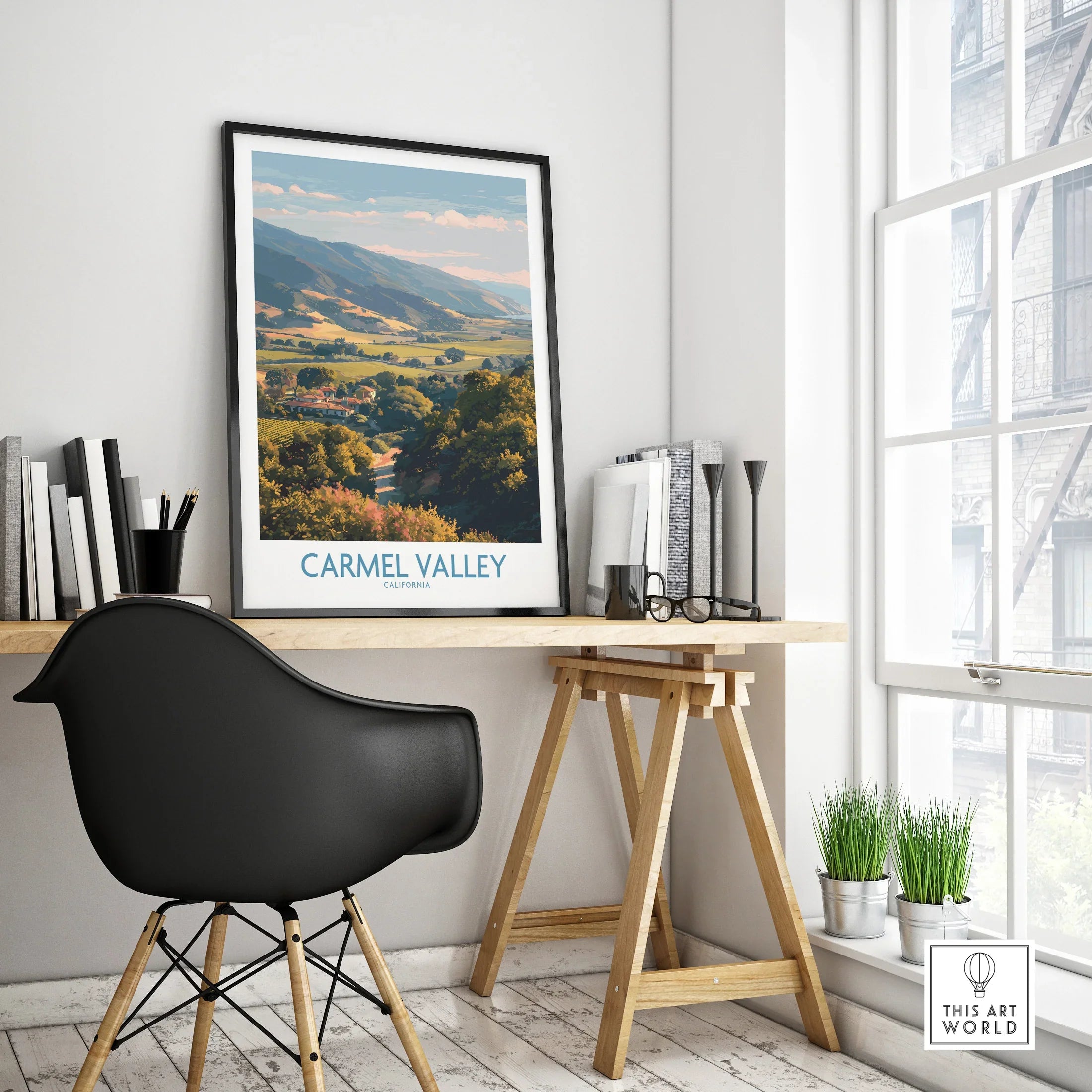 Framed Carmel Valley travel poster on modern home office desk with black chair