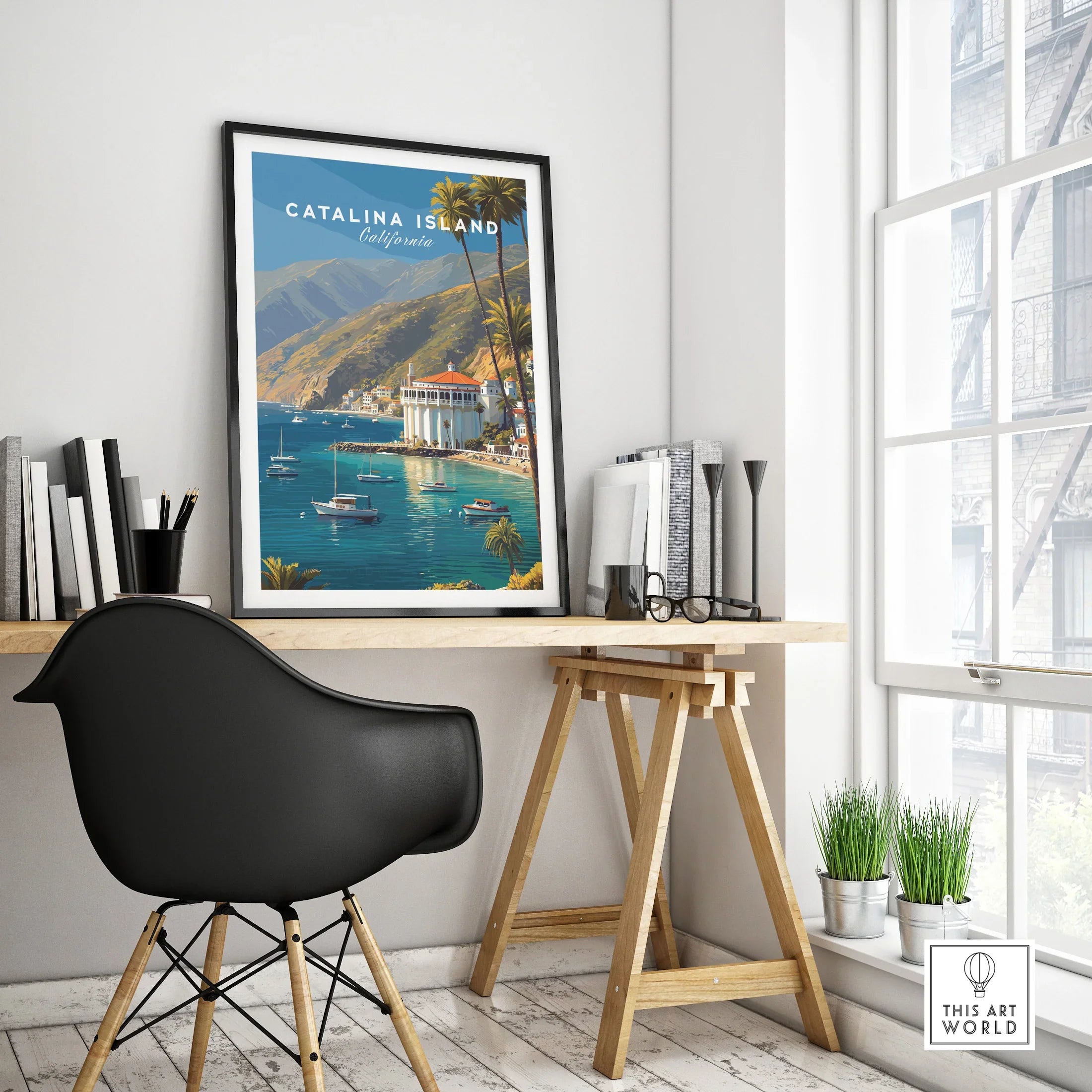 Catalina Island travel poster with boats and palm trees in black frame on modern office desk