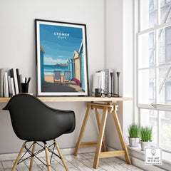 Cromer Travel Poster – Norfolk Beach Huts Art Print displayed in a modern study with coastal decor.