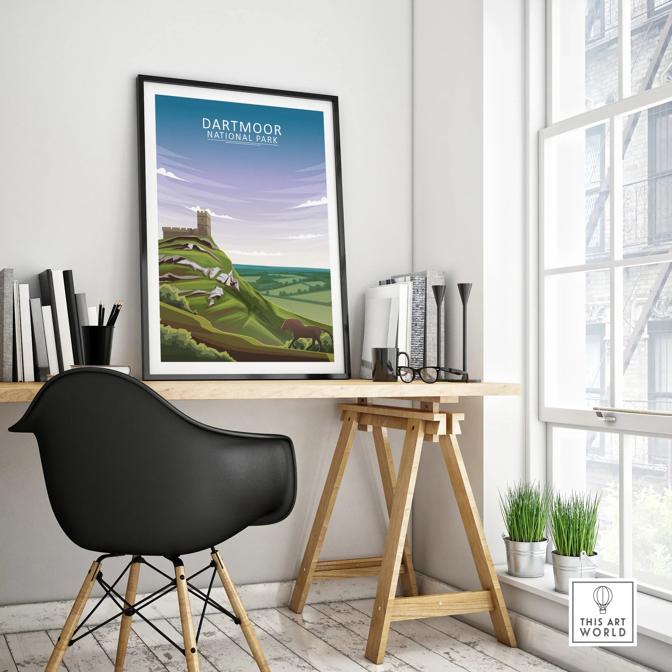 Framed Dartmoor National Park travel poster on modern office desk with black chair