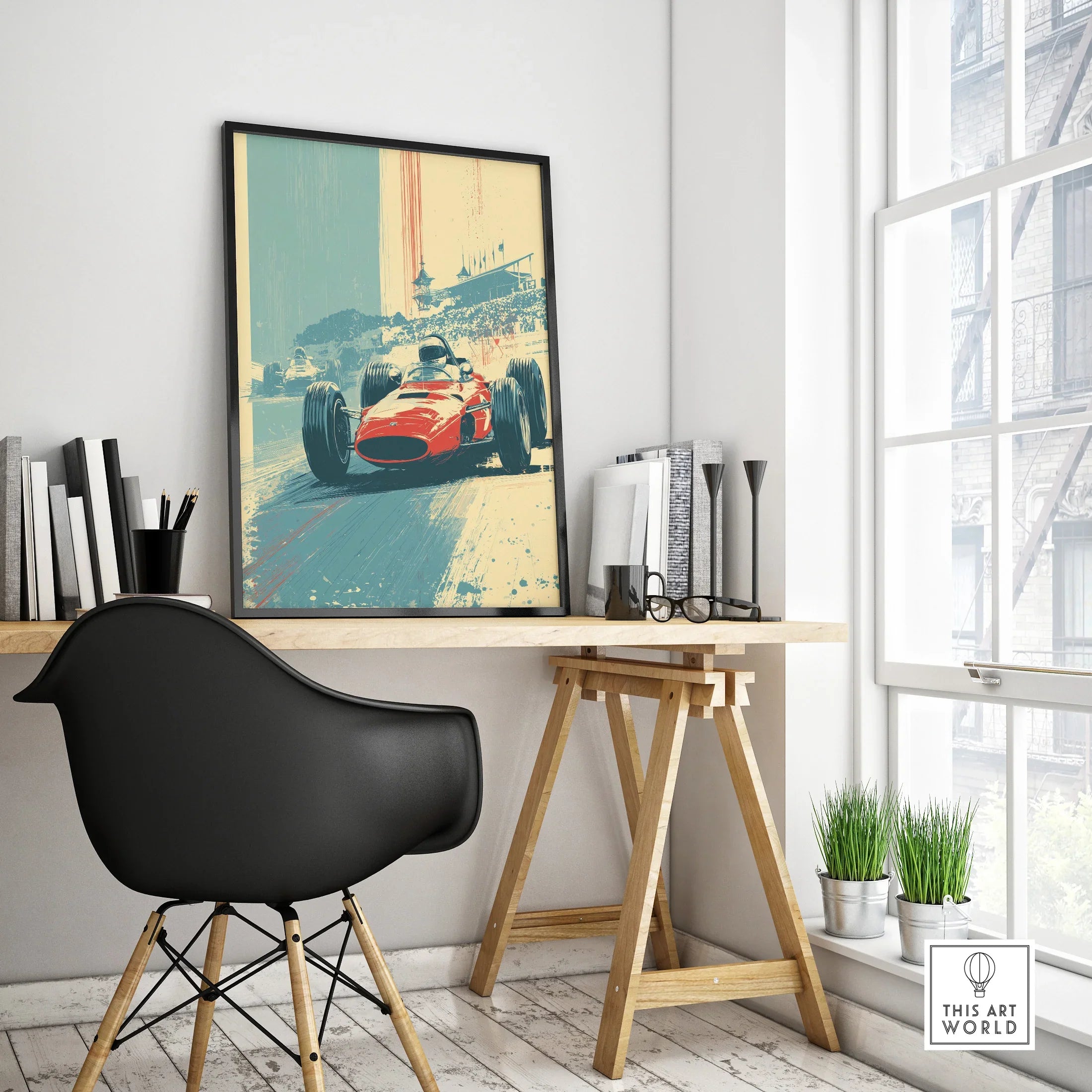 Framed vintage race car art print on modern office desk with black chair and books