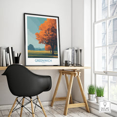 Modern office desk with framed Greenwich travel poster, black chair, and minimal decor