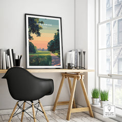 Framed Greenwich London travel poster on modern office desk with black chair, natural light