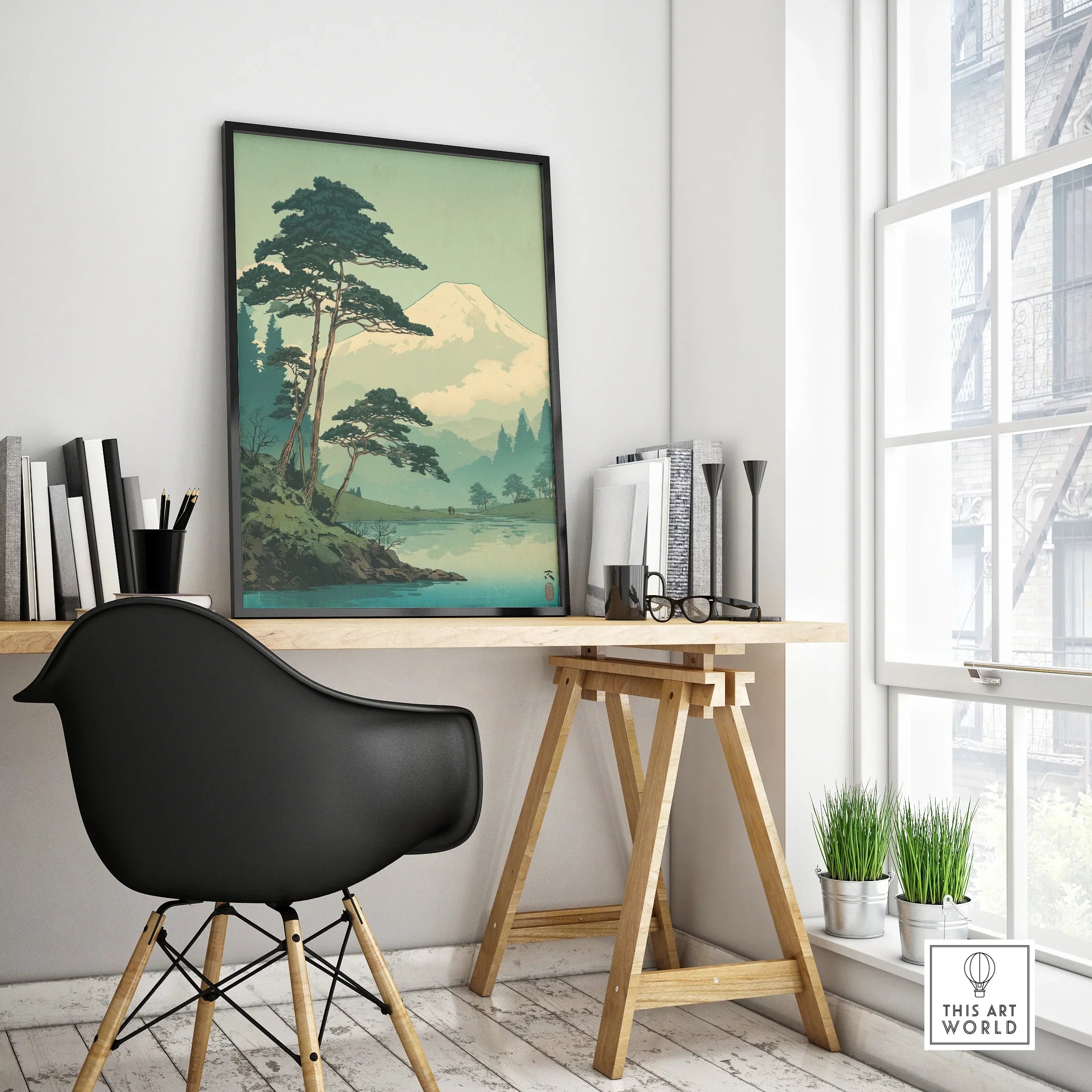 Framed Japan woodblock landscape poster on modern office desk with mountains and trees