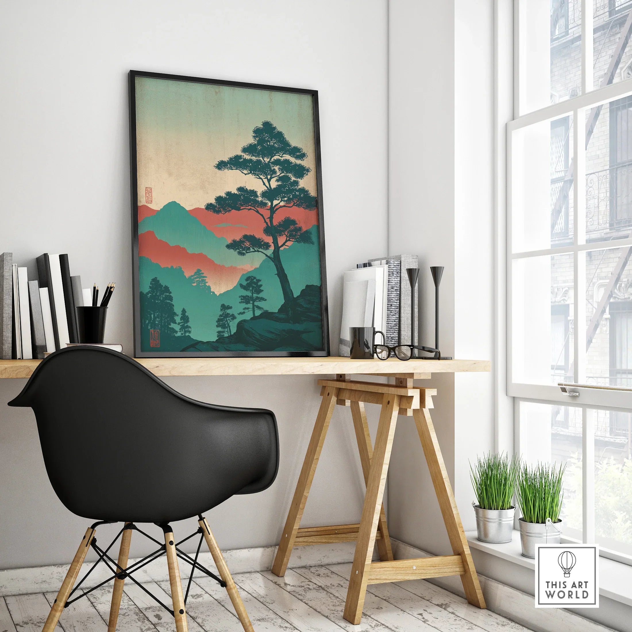 Modern office desk with framed Japanese woodblock style mountain art and black chair