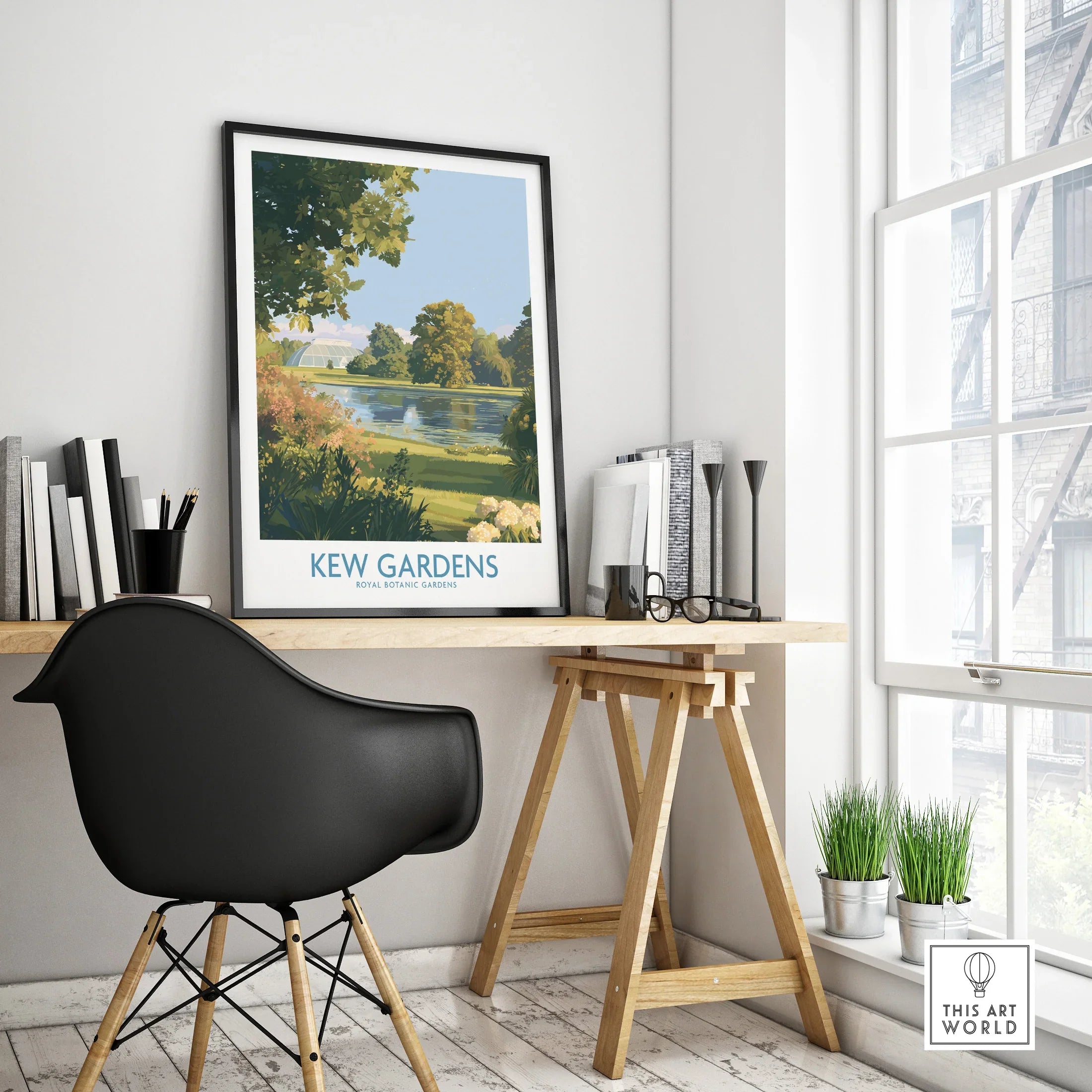 Framed Kew Gardens travel poster on modern office desk with black chair and decor.