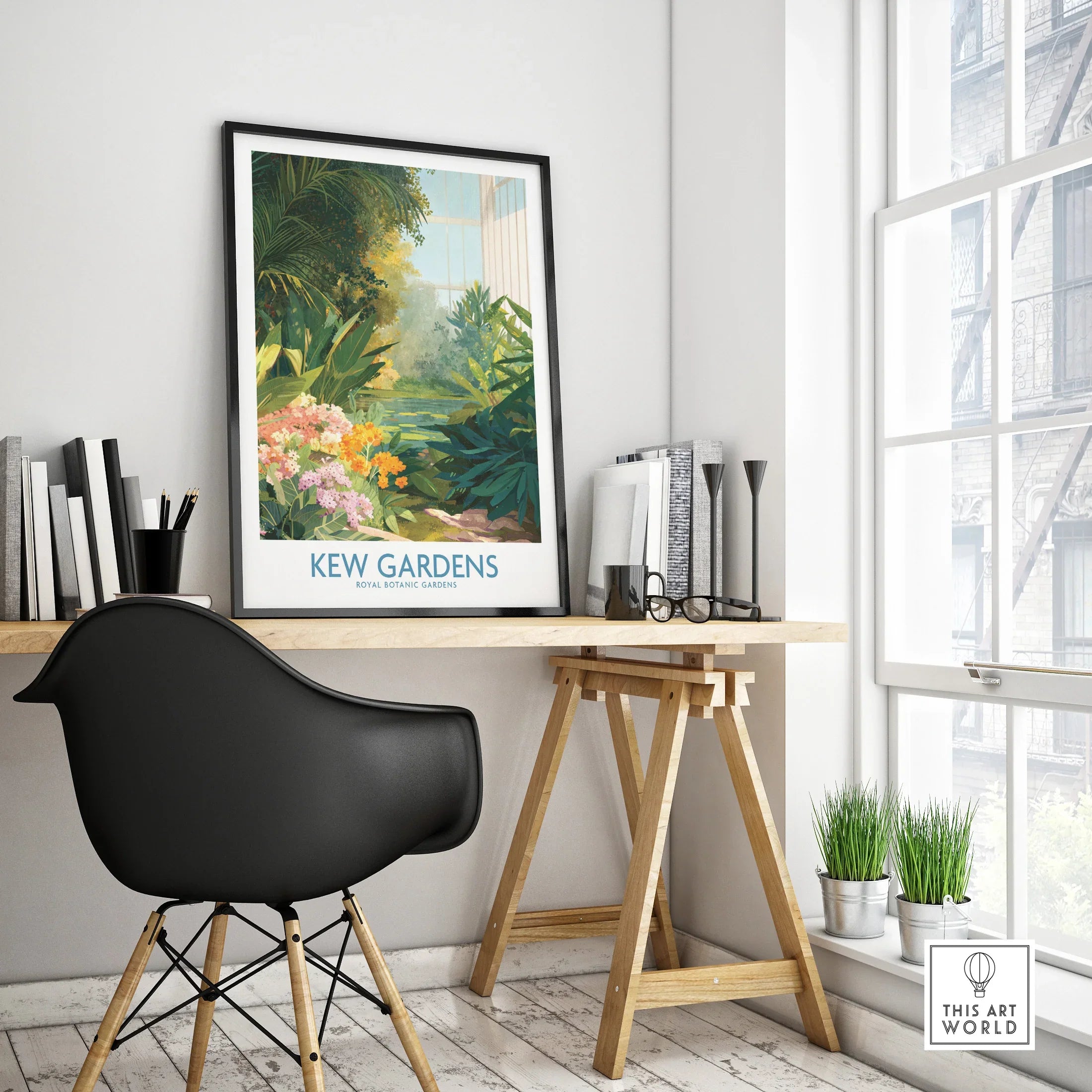 Kew Gardens travel poster with botanical illustration in black frame on modern office desk