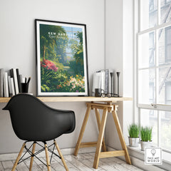Kew Gardens travel poster with botanical artwork in black frame on modern office desk