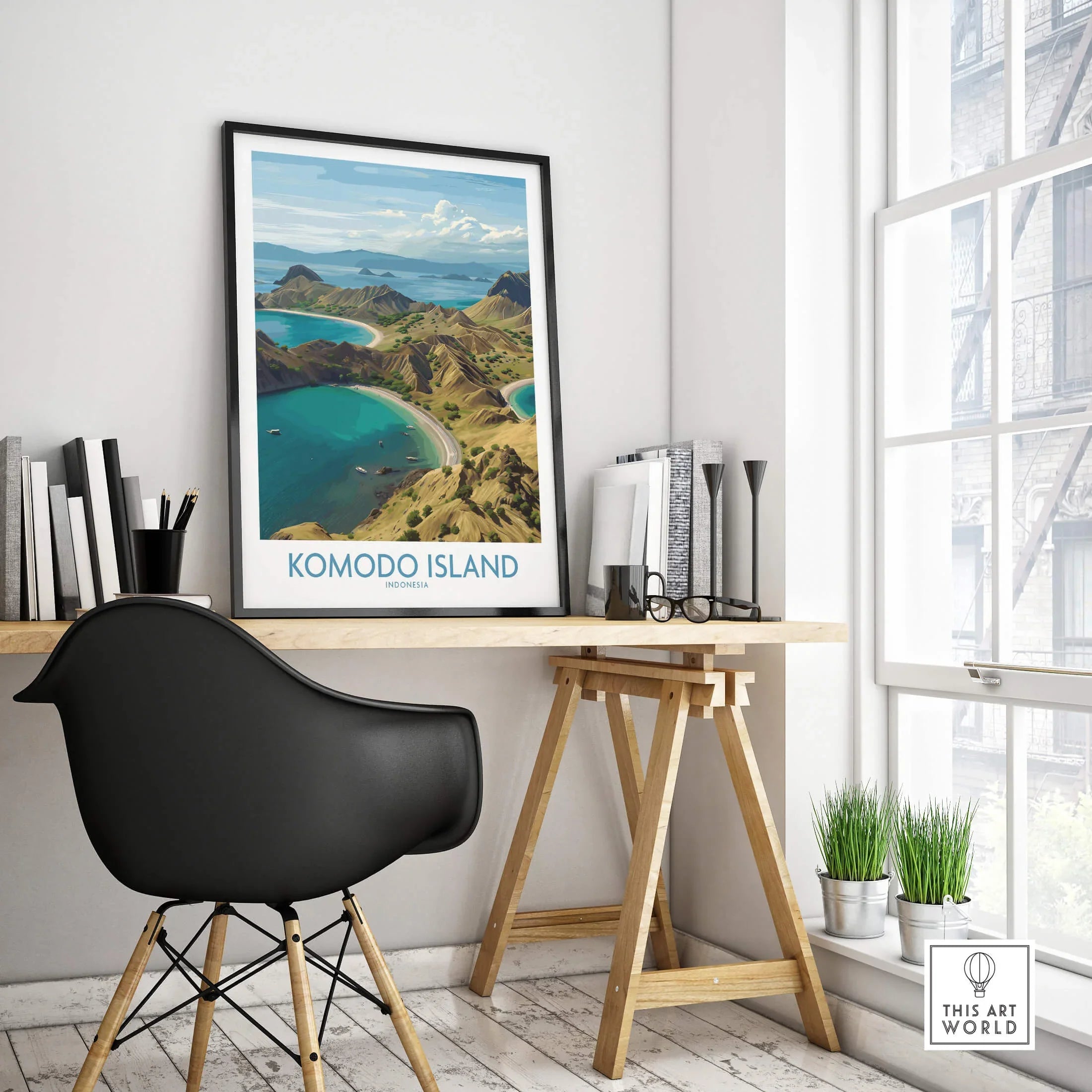 Komodo Island travel poster in black frame on modern office desk with decor and chair