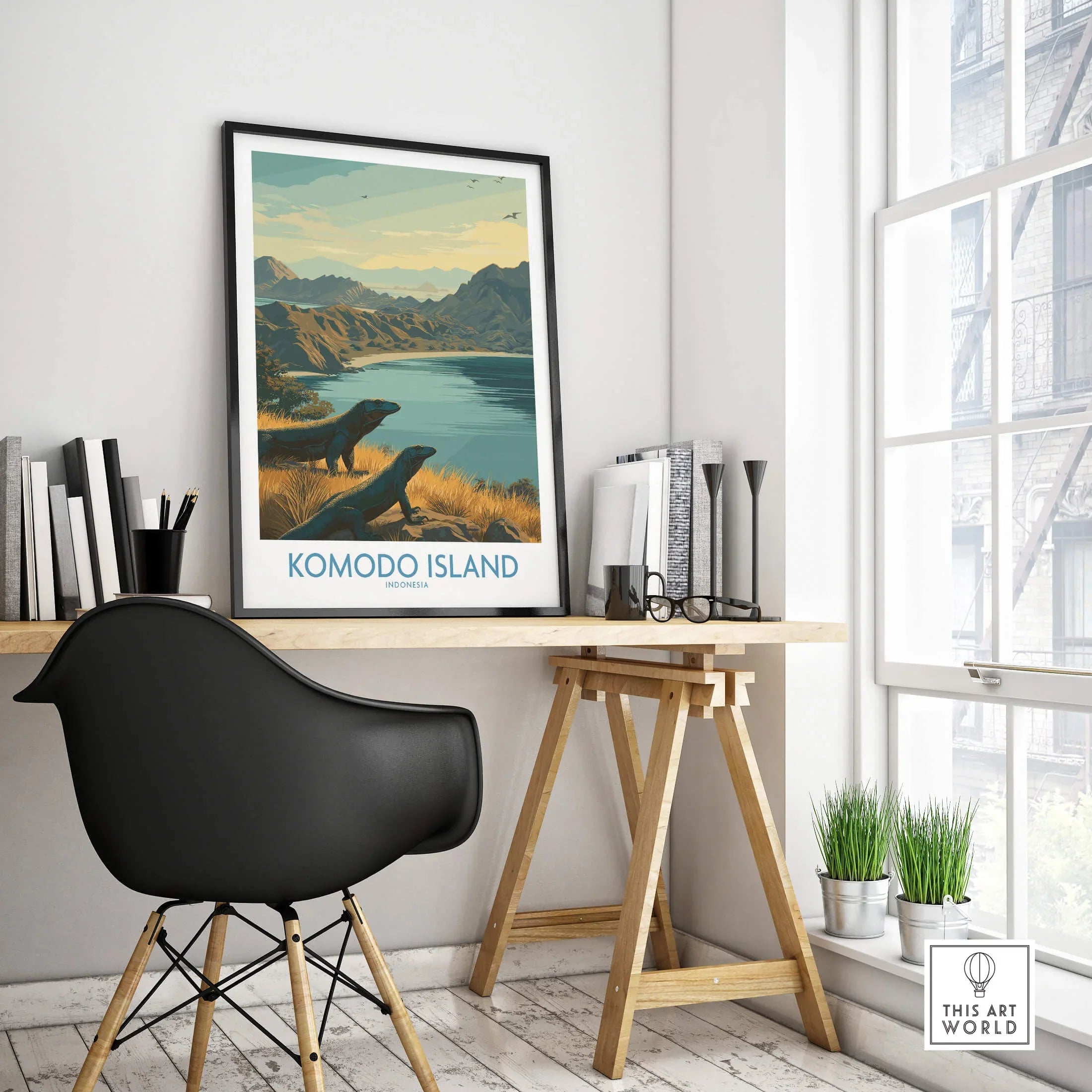 Framed Komodo Island travel poster on modern office desk near window, chair, and books