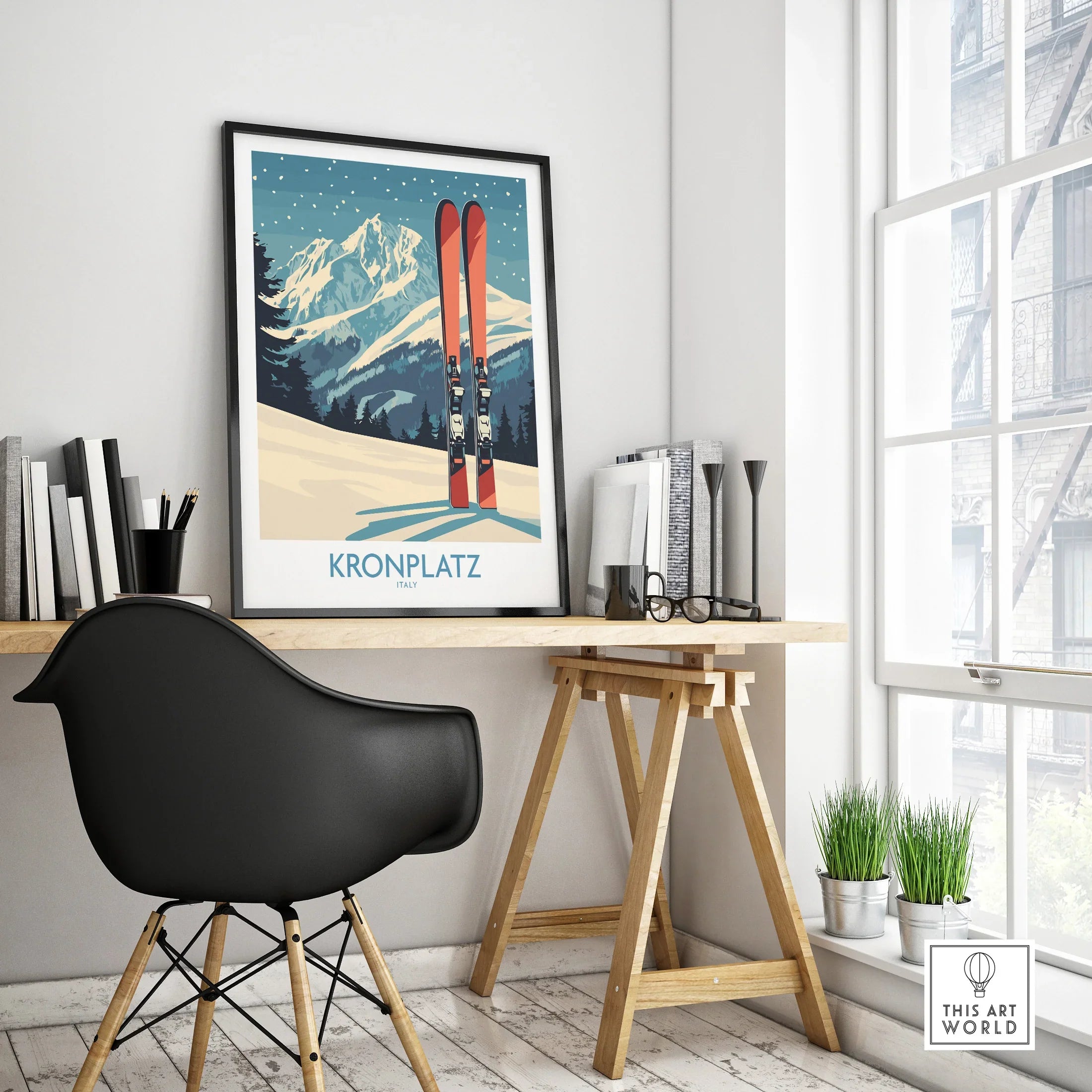Framed Kronplatz ski travel poster on a modern office desk near window