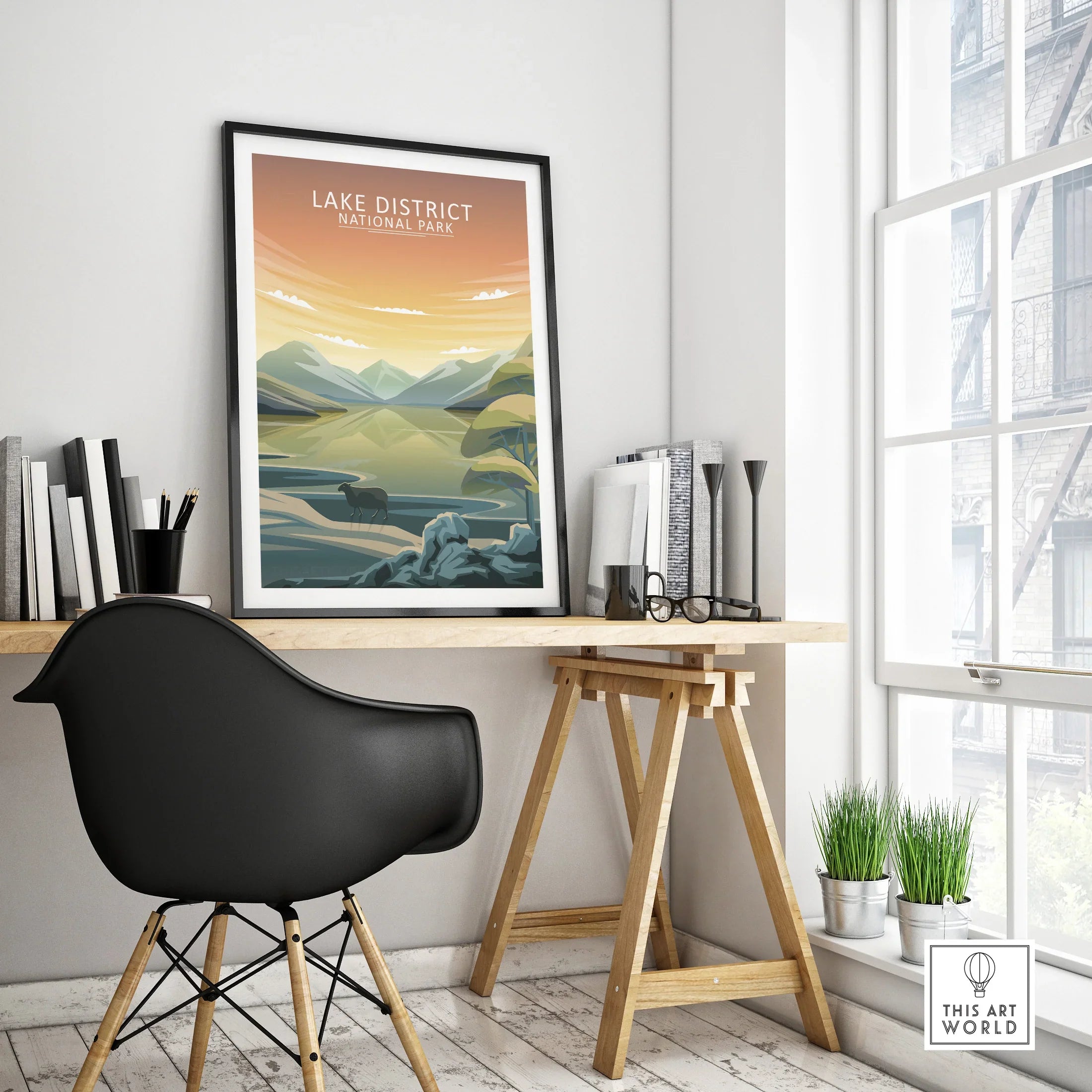 Framed Lake District National Park travel poster on modern office desk with black chair