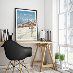Framed Les Menuires ski resort travel poster on modern office desk with black chair