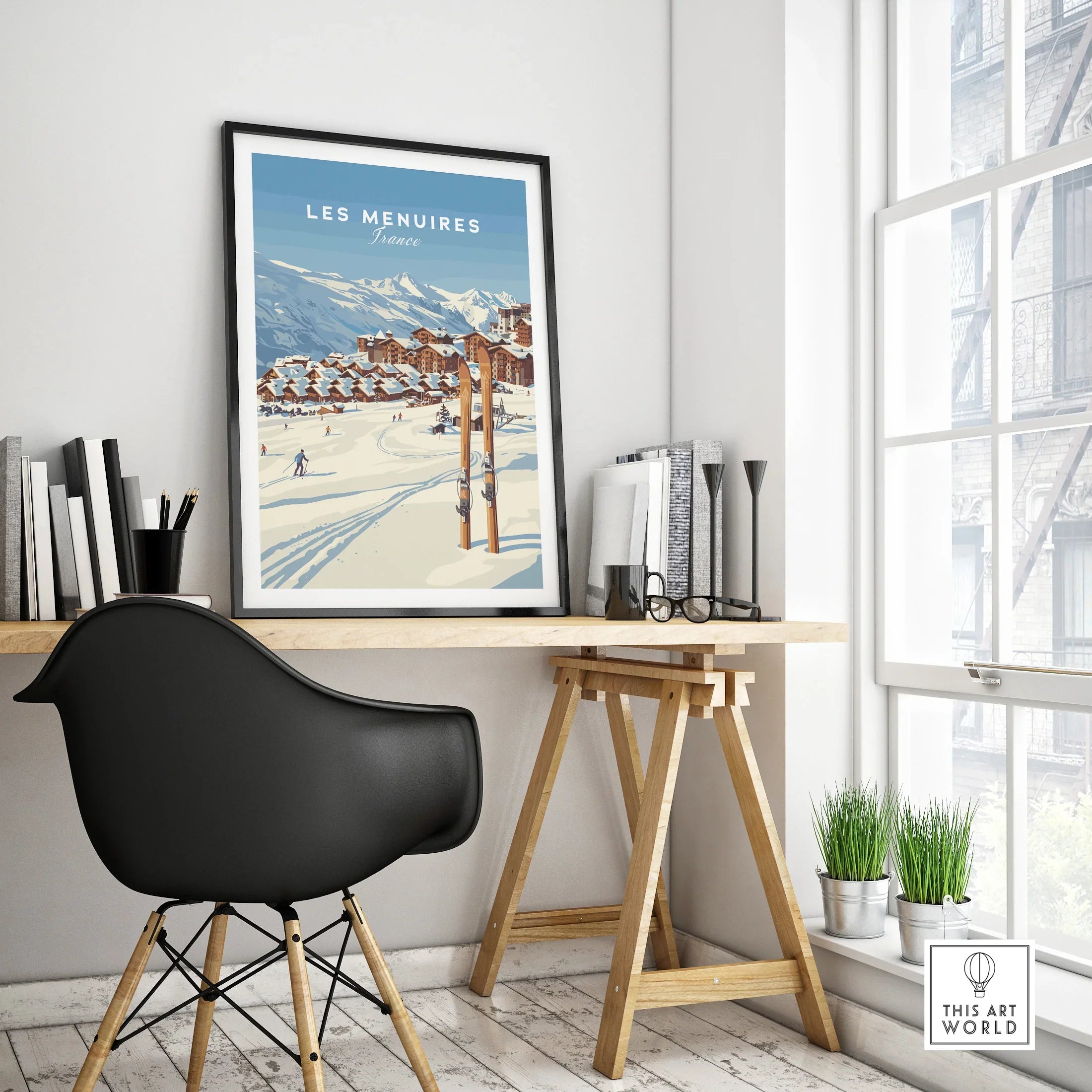 Framed Les Menuires ski resort travel poster on modern office desk with black chair