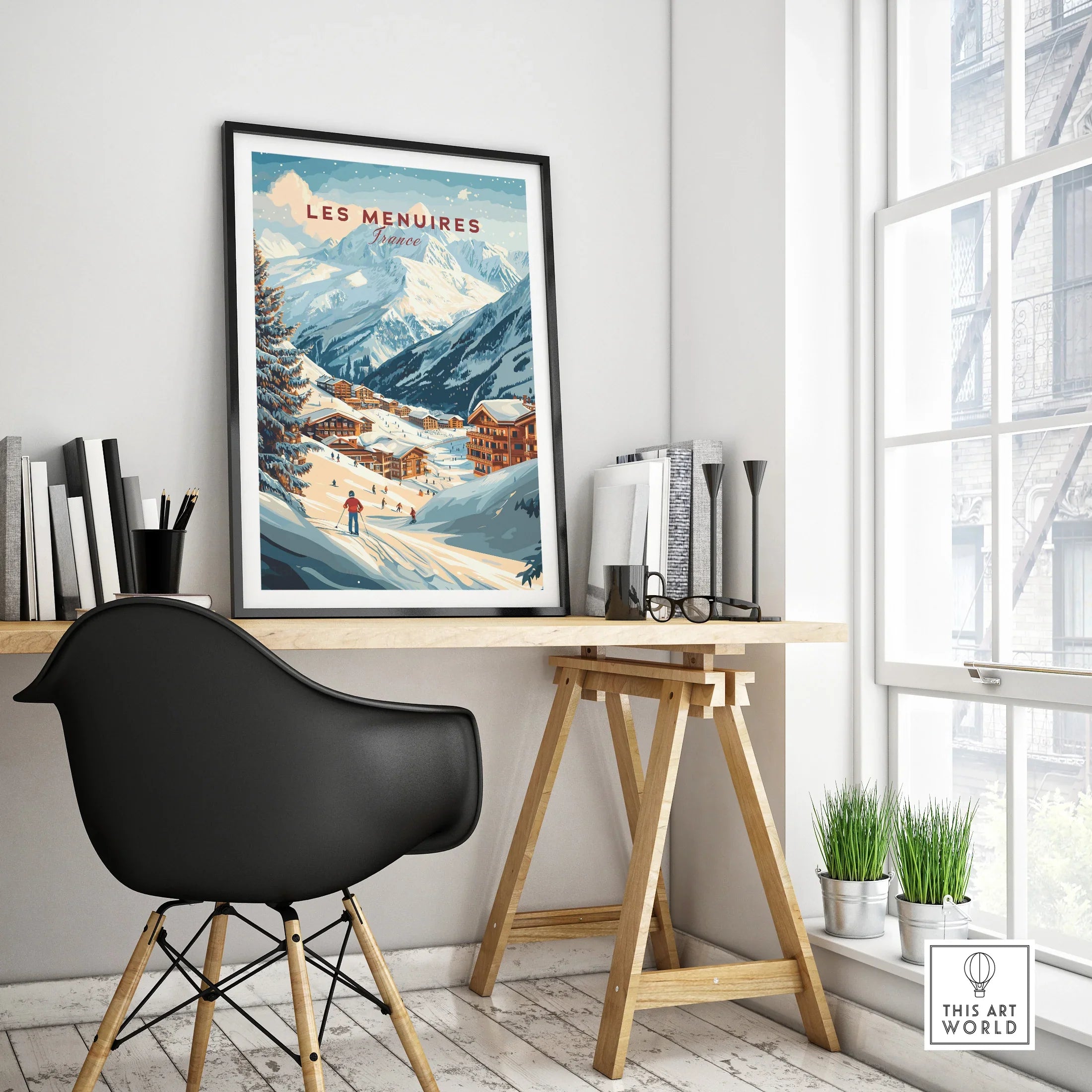 Les Menuires France travel poster in black frame on modern office desk with mountain wall art decor