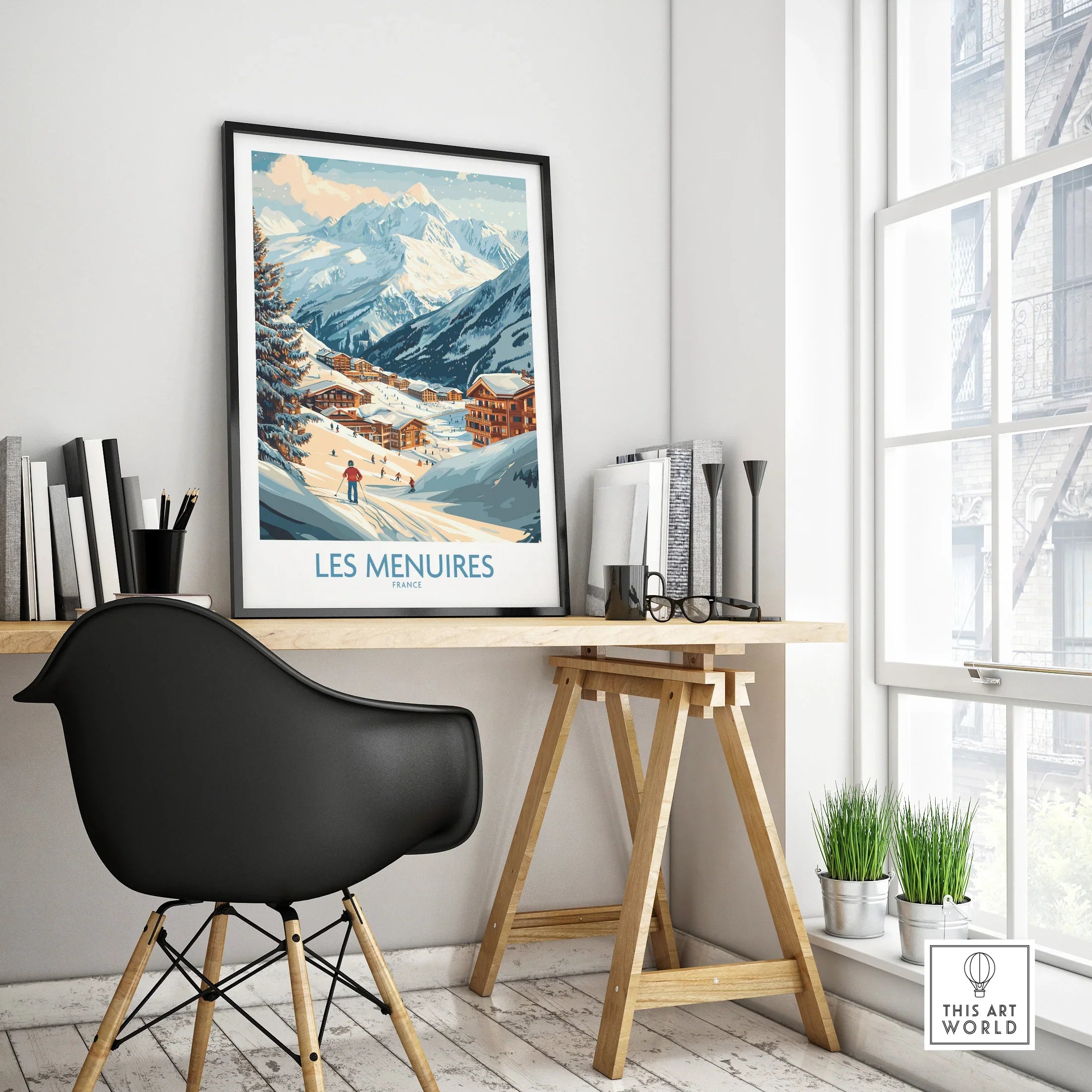 Framed Les Menuires travel poster on modern office desk, with mountain ski scene art
