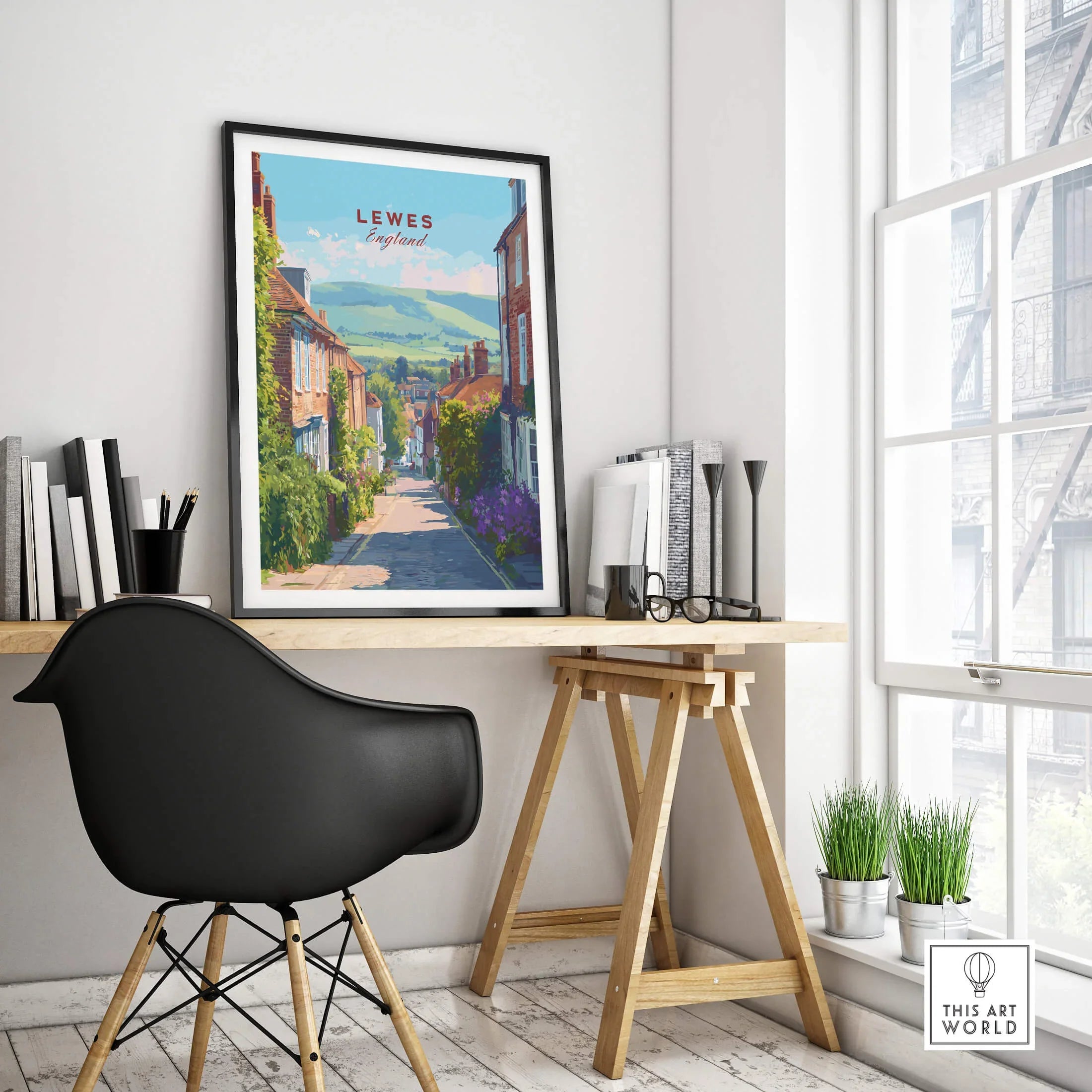 Framed Lewes England travel poster on modern office desk, cityscape wall art decor