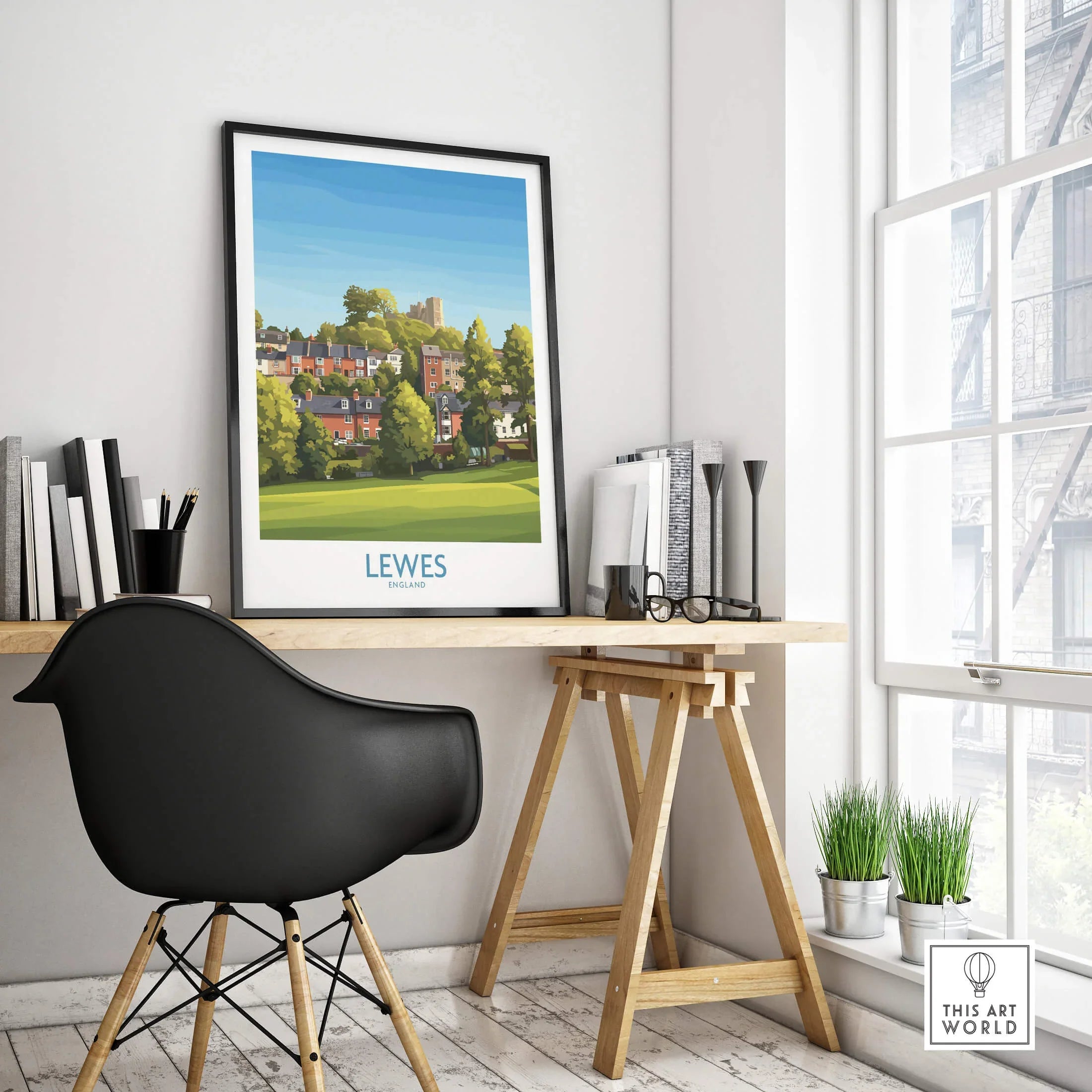 Lewes travel poster in black frame on modern office desk with chair, books, and plants