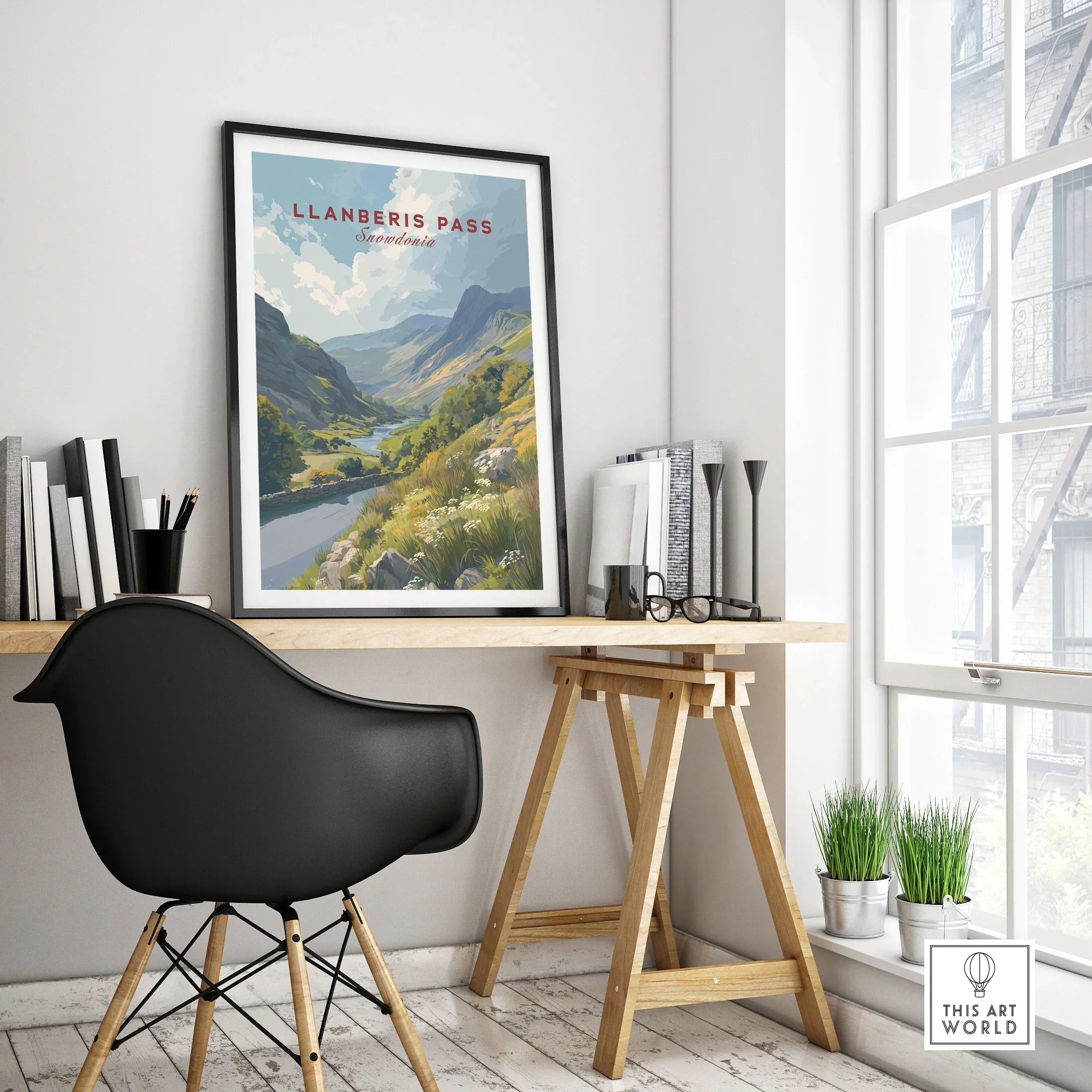 Framed Llanberis Pass travel poster on modern office desk with natural light