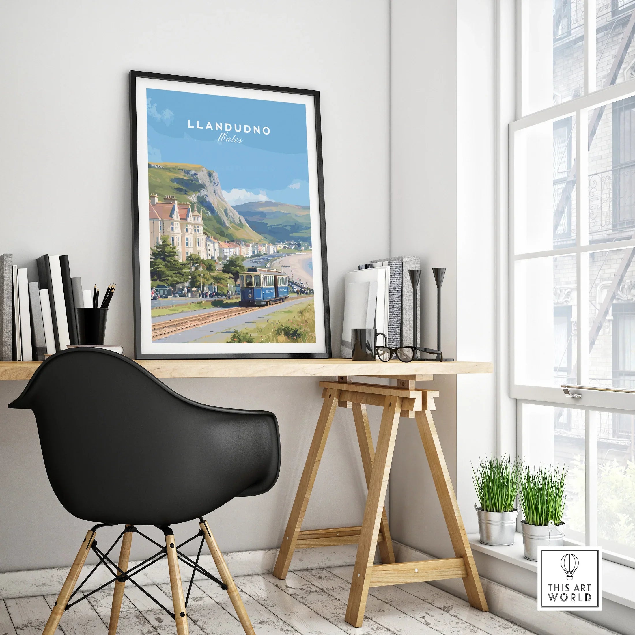 Llandudno travel poster in black frame on modern office desk with books and decor