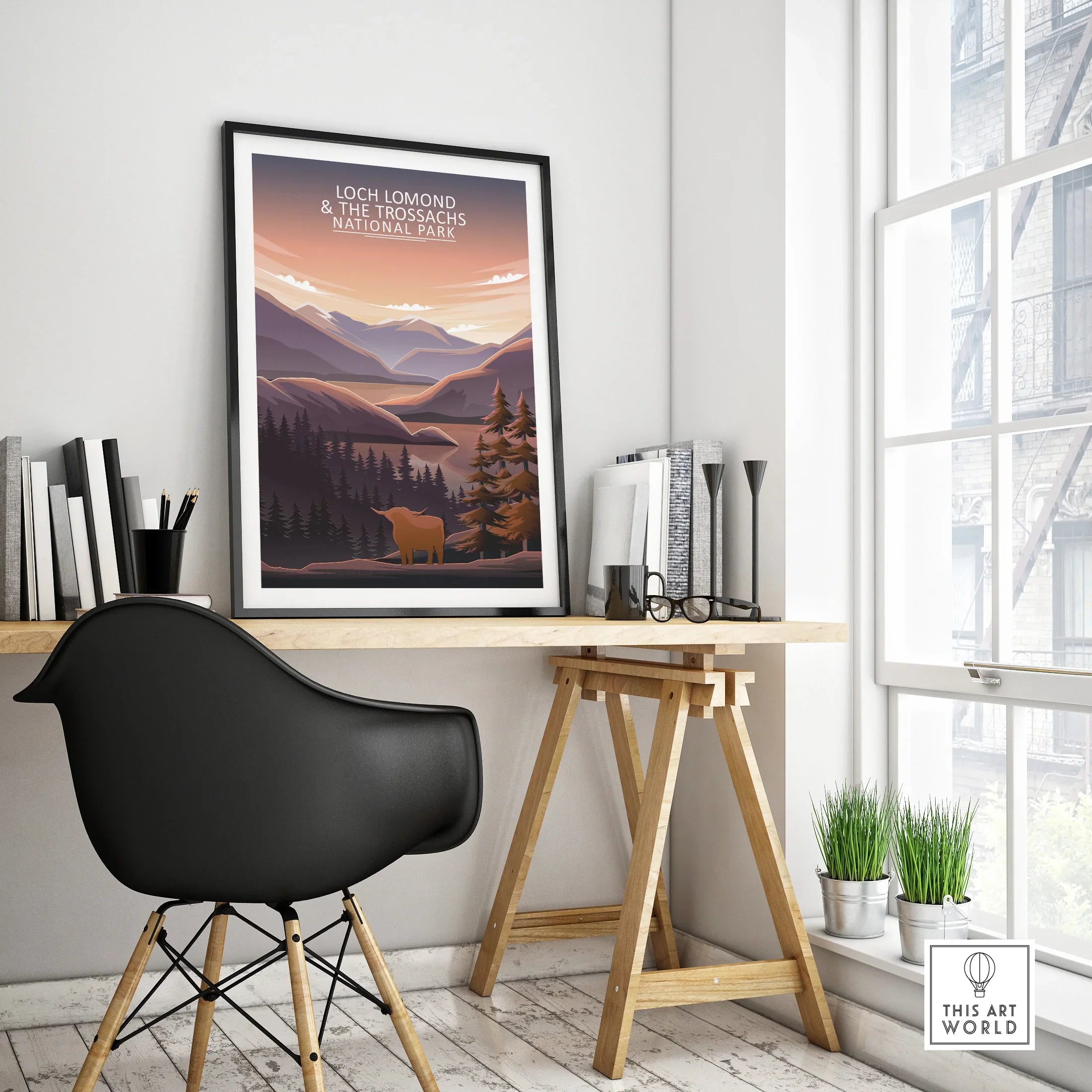 Framed Loch Lomond and The Trossachs National Park travel poster on modern office desk