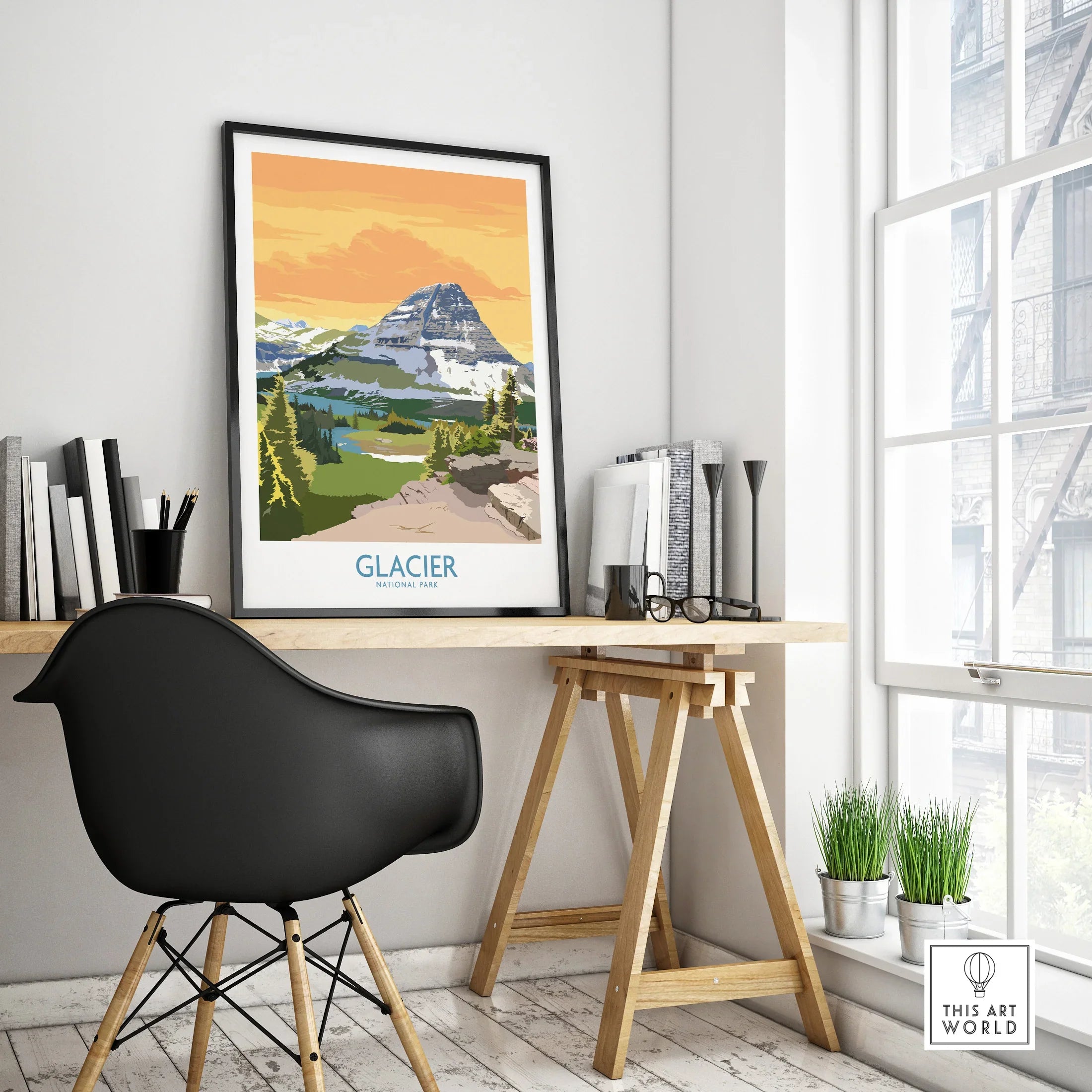 Glacier National Park travel poster in black frame on modern office desk near window
