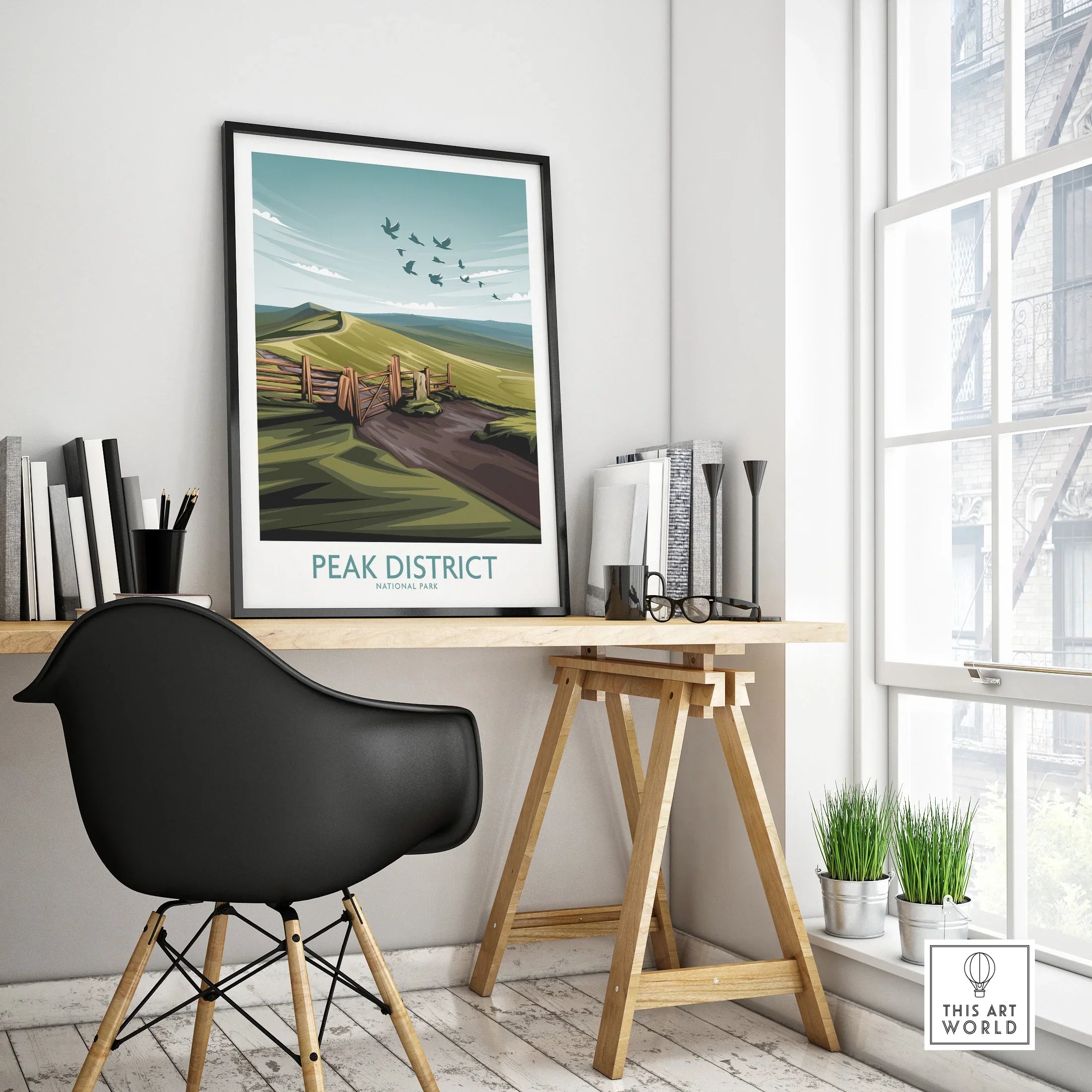 Framed Peak District National Park poster on modern office desk with black chair and decor