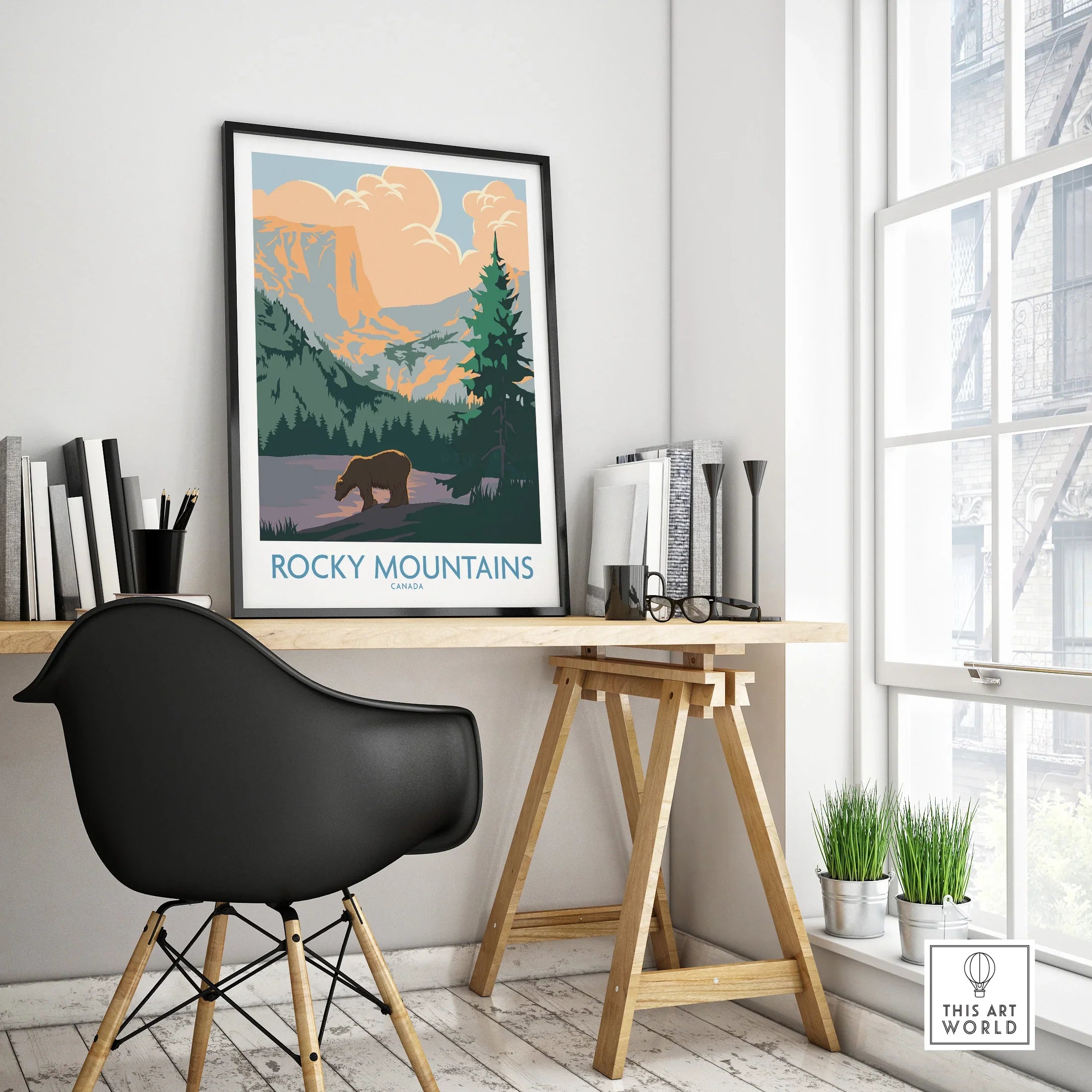 Rocky Mountains Canada travel poster in black frame on modern office desk, minimalist decor