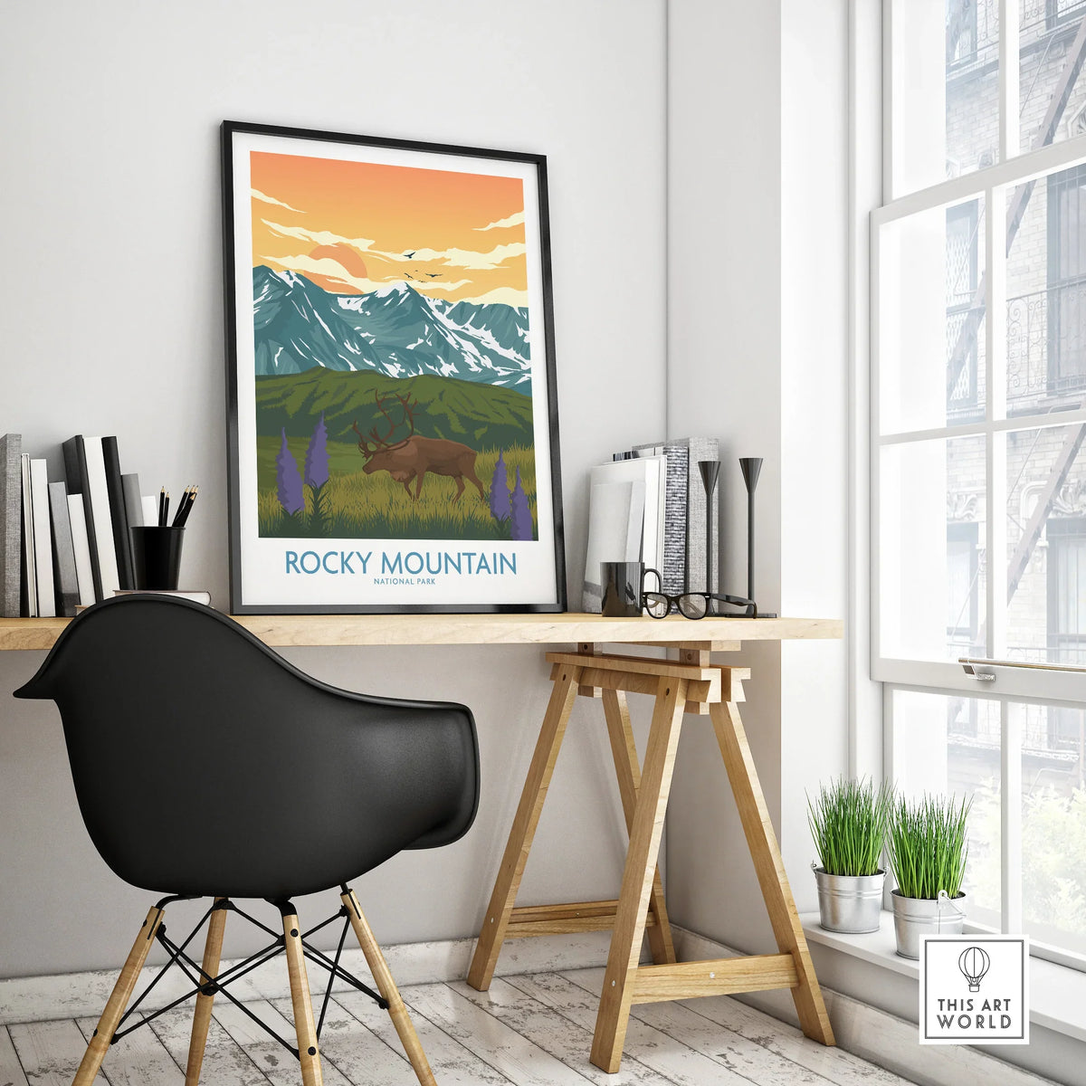 Rocky Mountain National Park travel poster with elk, on modern office desk by a window
