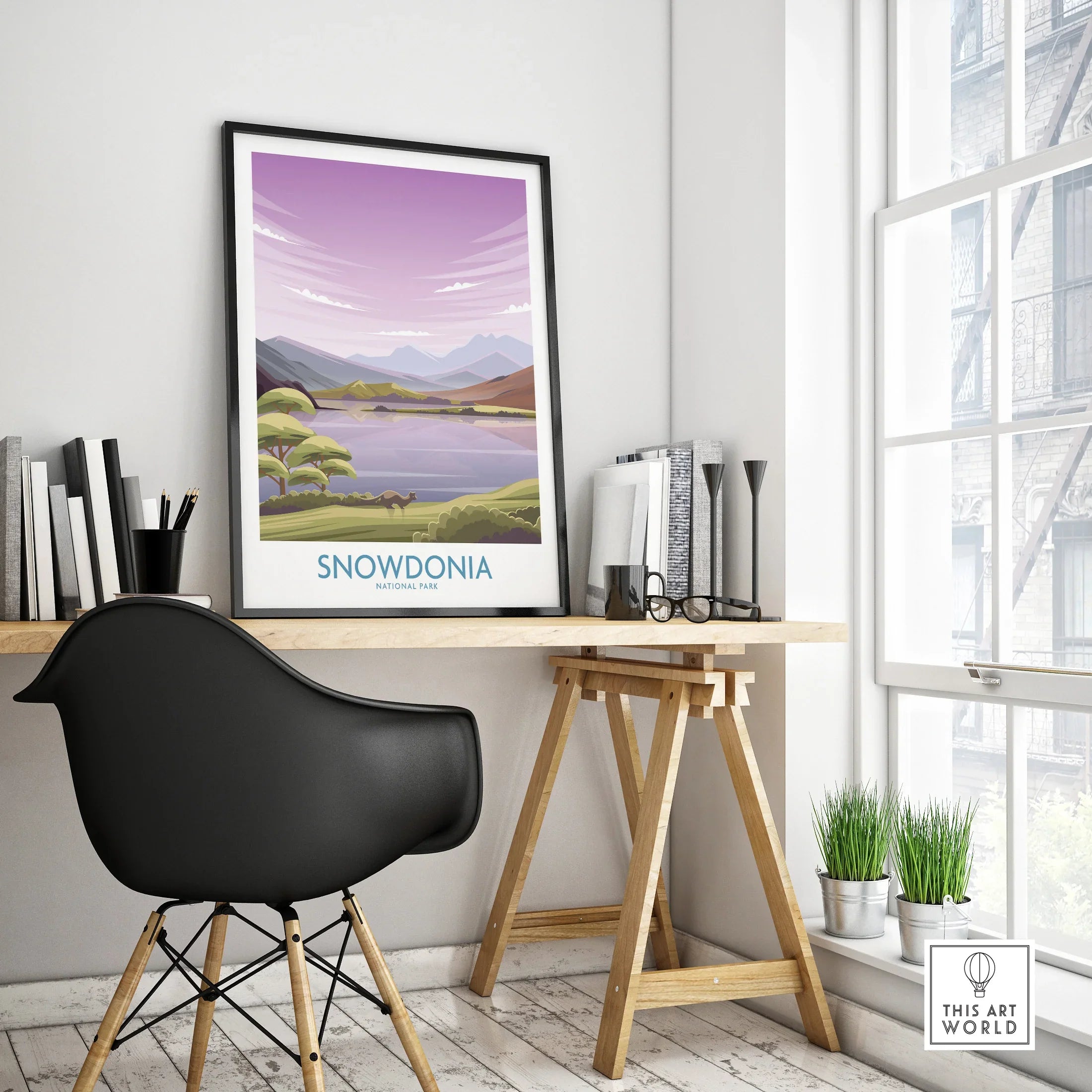 Framed Snowdonia National Park travel poster on modern office desk with minimalist decor
