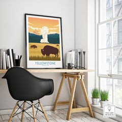 Yellowstone National Park poster with bison and geyser in black frame on modern desk