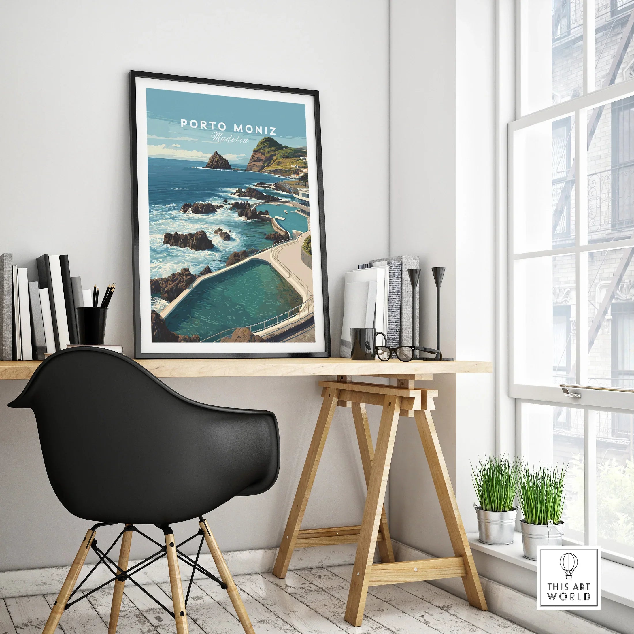 Framed Porto Moniz Madeira travel poster on modern office desk, cityscape wall art decor