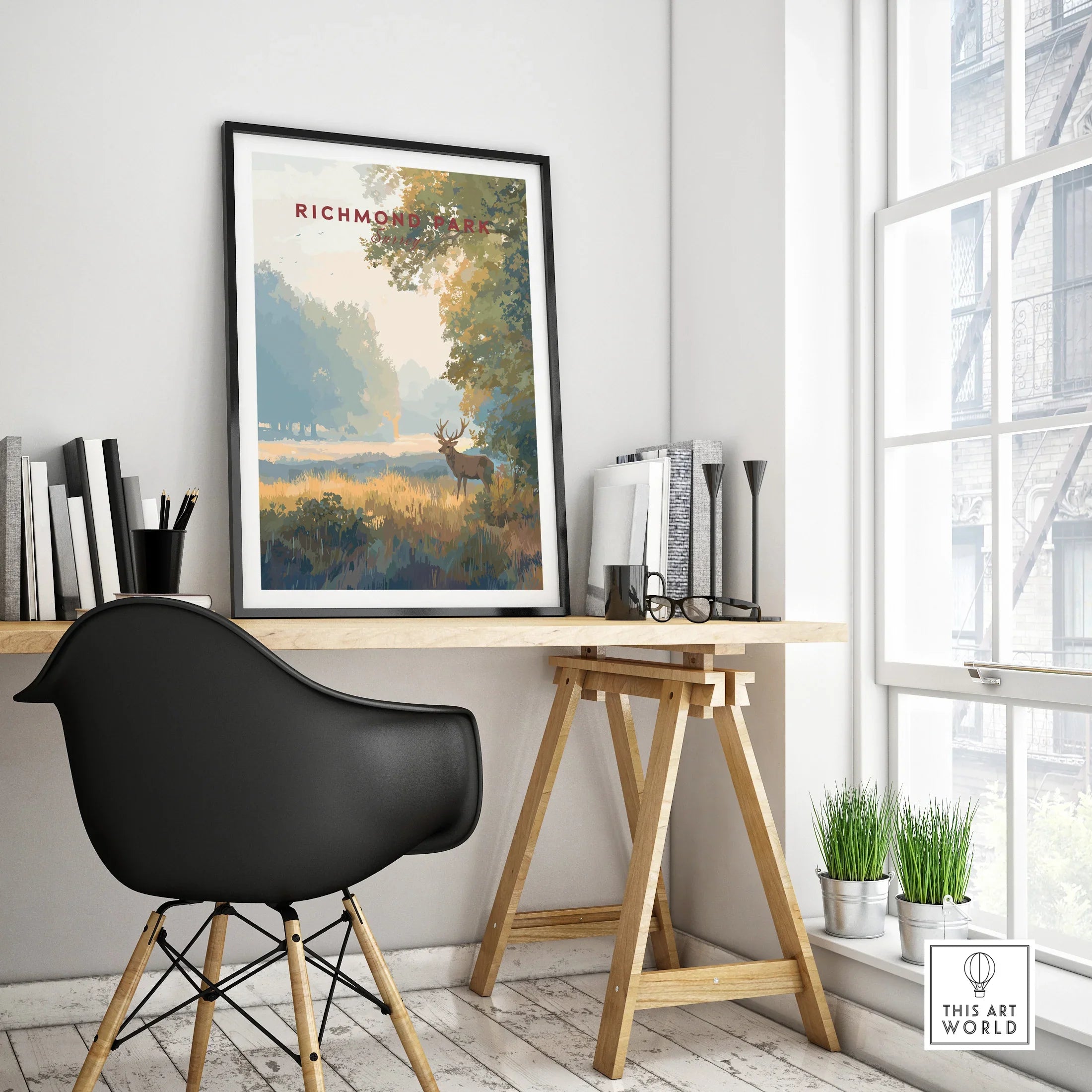 Richmond Park travel poster in black frame on modern office desk with decor accents