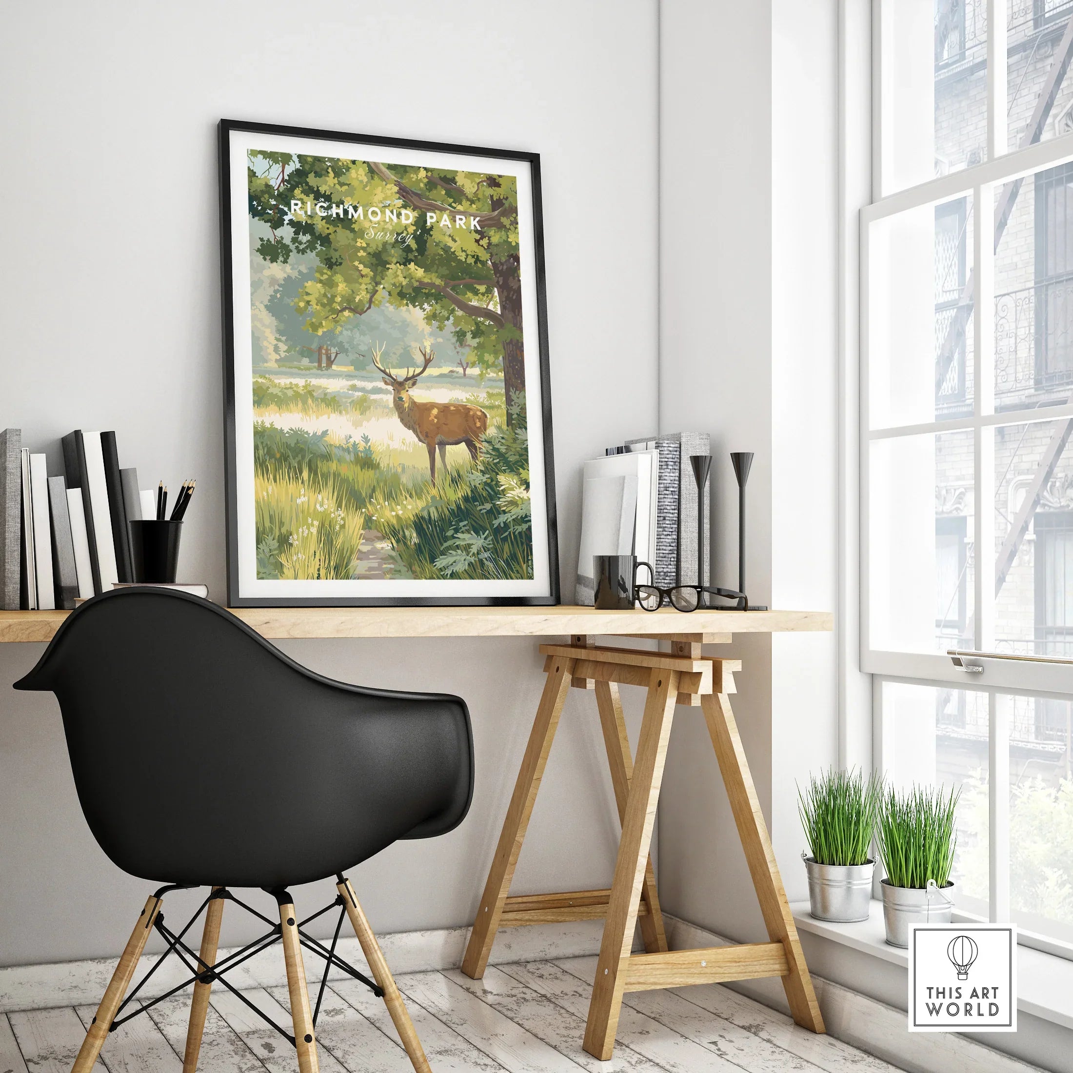 Framed Richmond Park travel poster with deer art on modern office desk, natural light decor