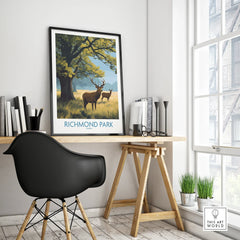 Richmond Park travel poster with deer in black frame on modern office desk