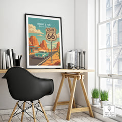 Framed Route 66 travel poster on modern office desk, featuring vintage car and desert landscape.
