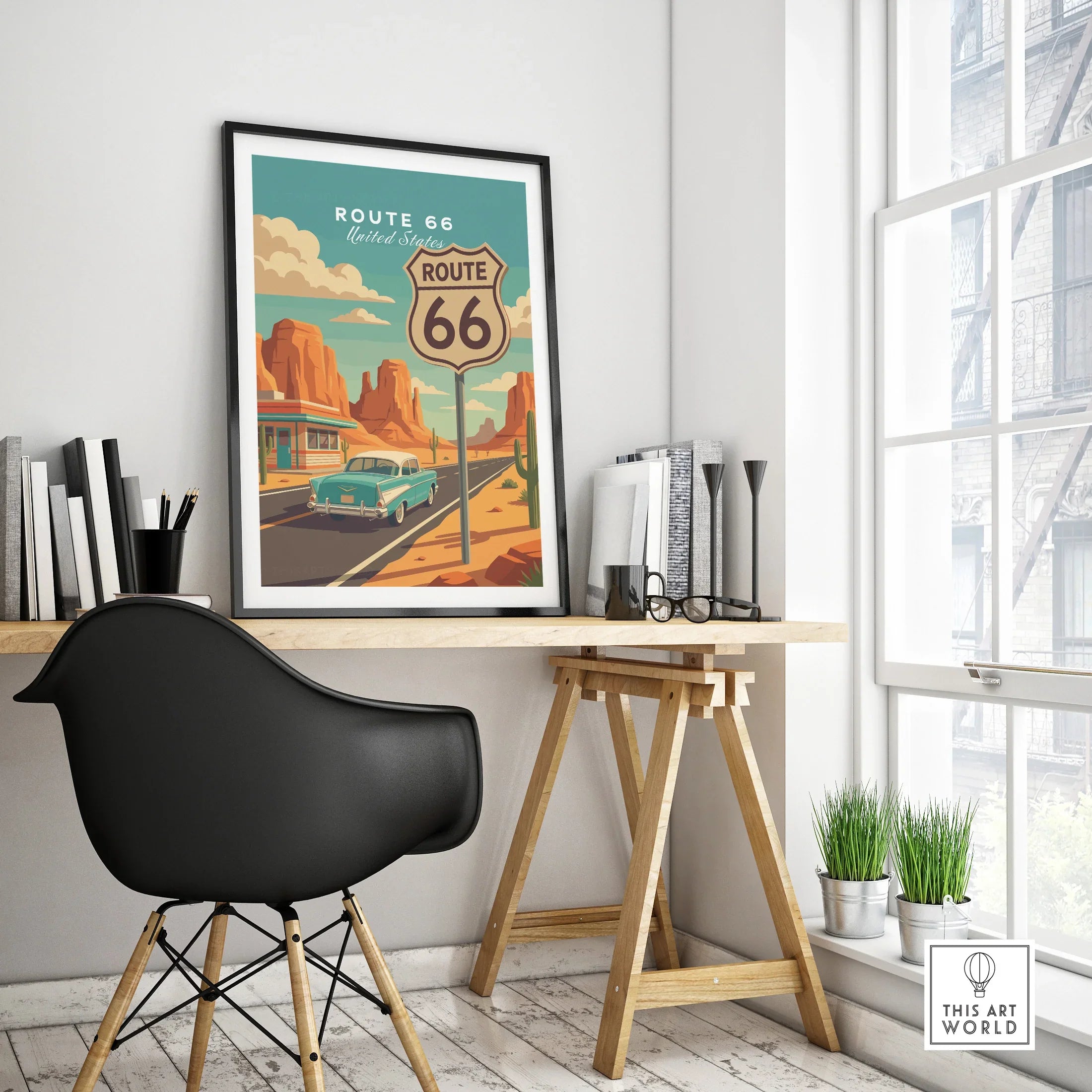 Framed Route 66 travel poster on modern office desk, featuring vintage car and desert landscape.
