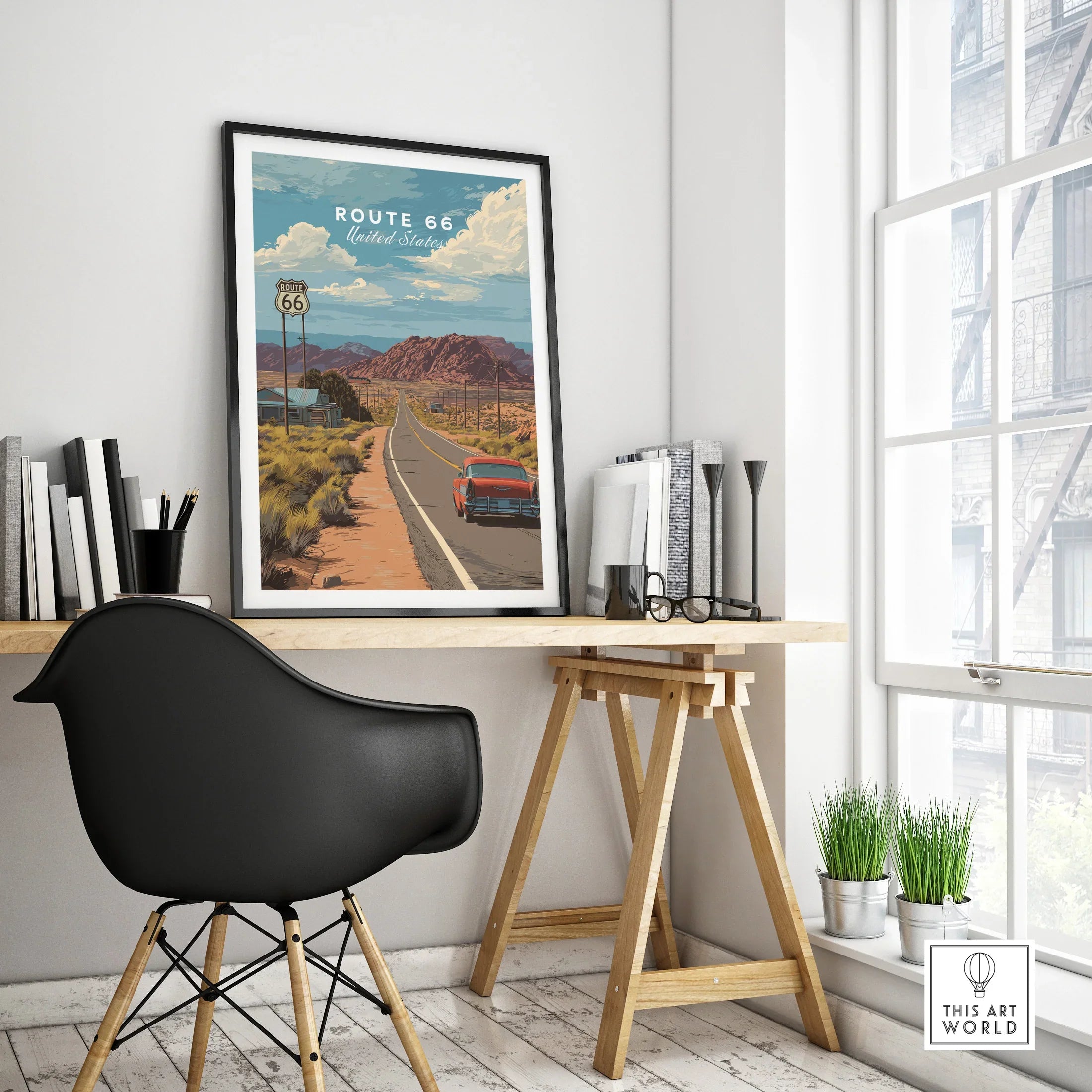 Framed Route 66 travel poster with classic car on a modern office desk by window
