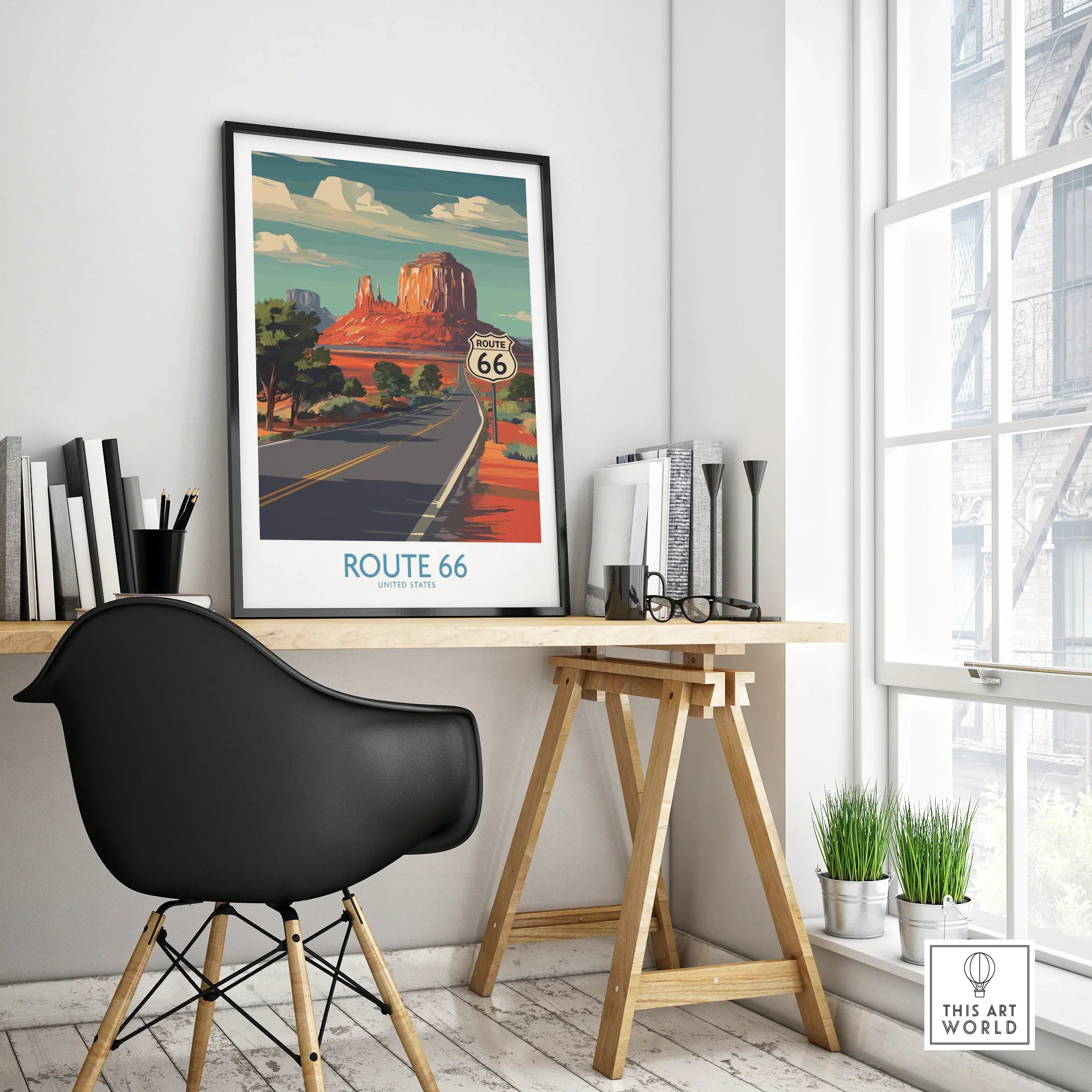 Framed Route 66 travel poster on modern office desk, black chair, bright decor