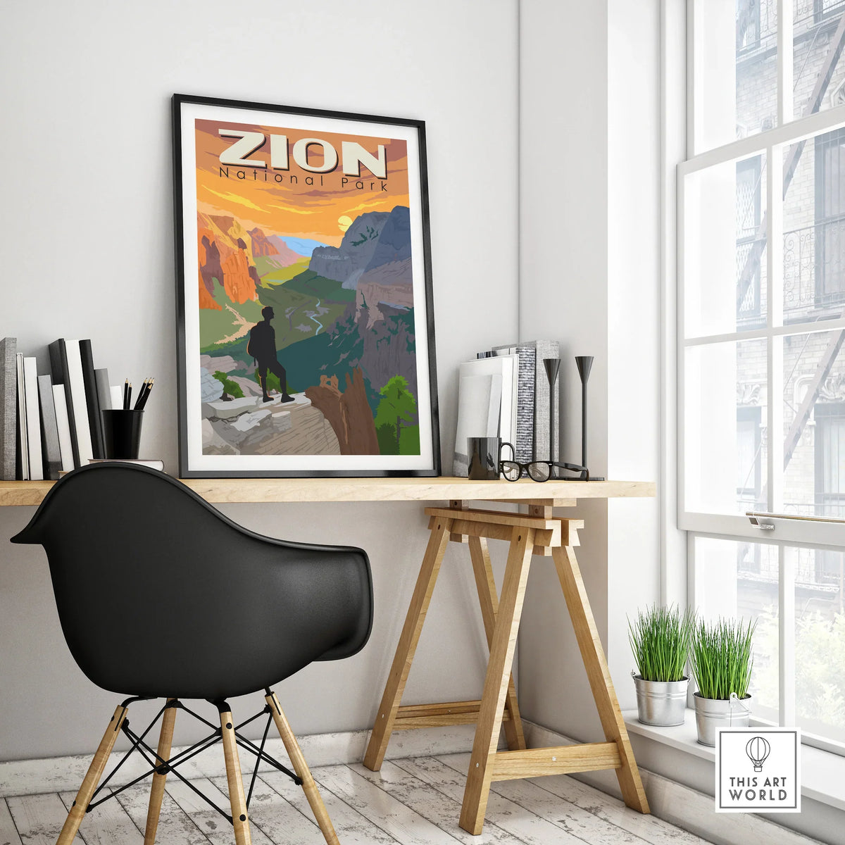 Framed Zion National Park travel poster on modern office desk near window