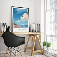 Cocoa Beach Kennedy Space Center Poster - Florida Wall Art Decor framed on a desk in a bright room with plants.