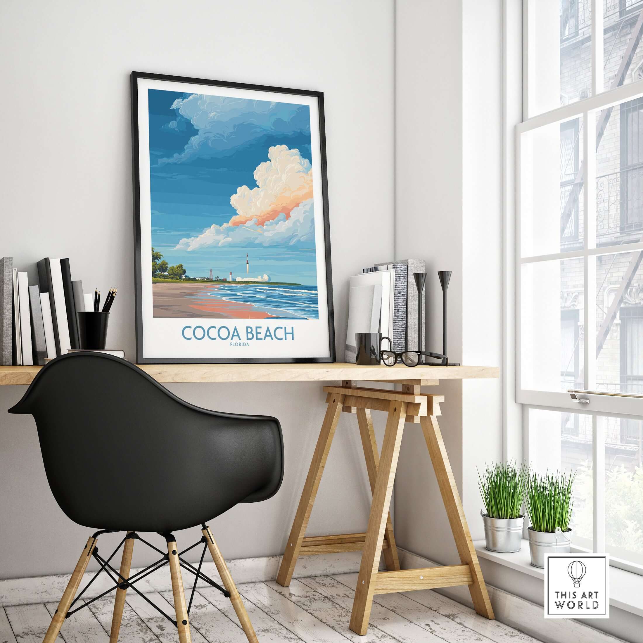 Cocoa Beach Kennedy Space Center Poster - Florida Wall Art Decor framed on a desk in a bright room with plants.