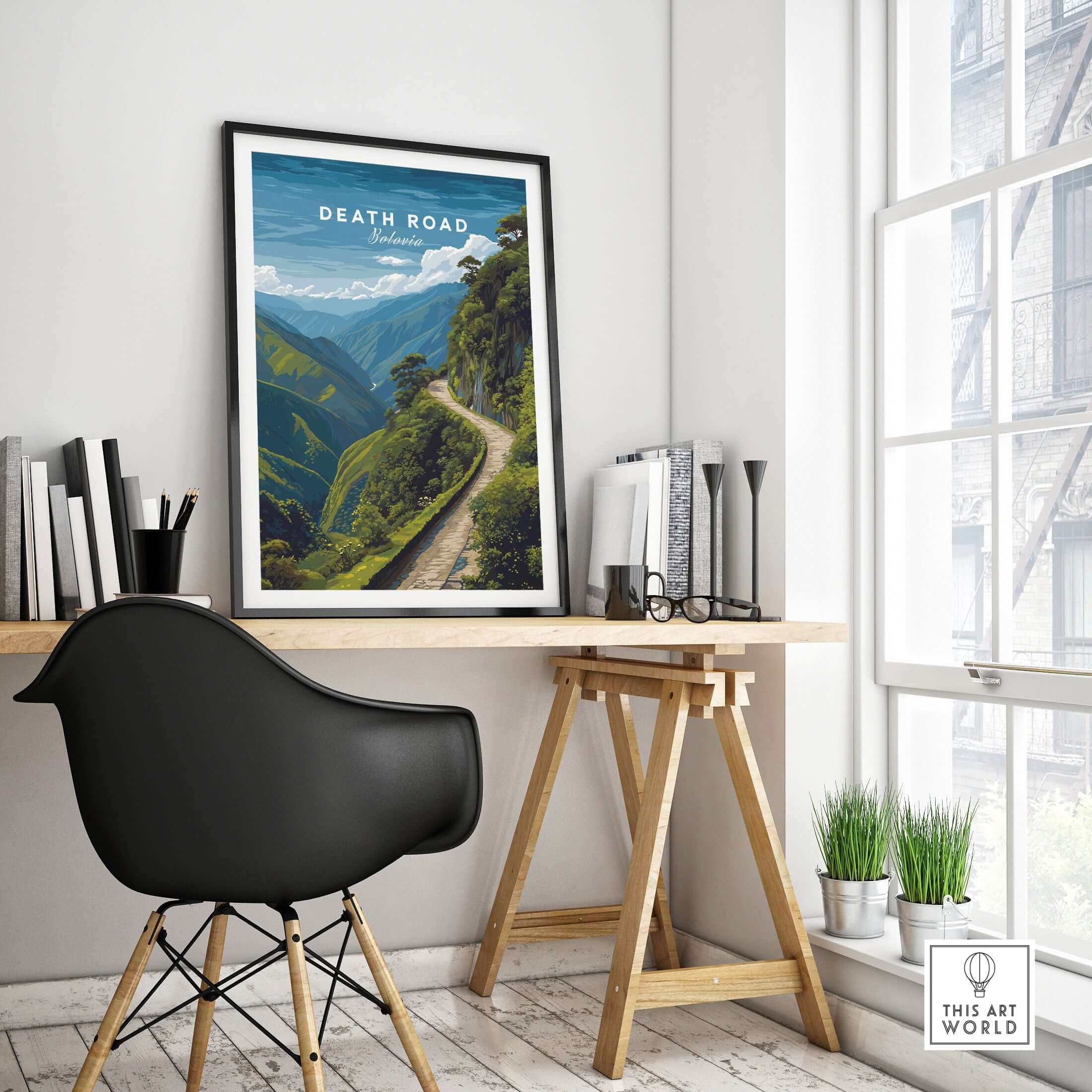 Death Road Andes Print | Yungas Road Poster displayed in a stylish workspace with a black chair and plants.